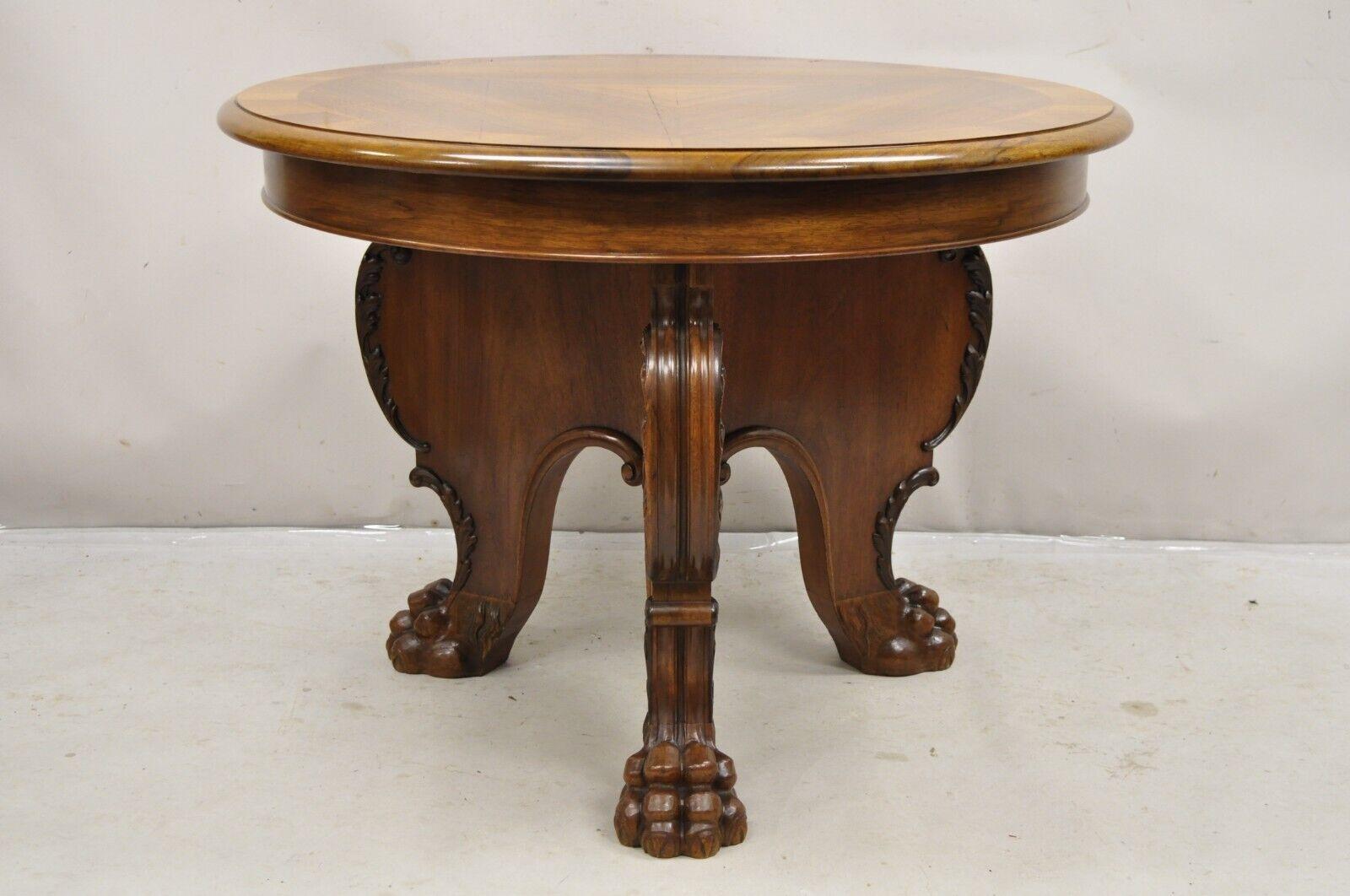 Antique German Renaissance Revival Carved Walnut Paw Feet Round Center Table by Leonardo Tisch. Item features a Tripod base with carved paw feet, round sunburst inlaid top, original German label, very nice antique table. Circa Early 1900s.