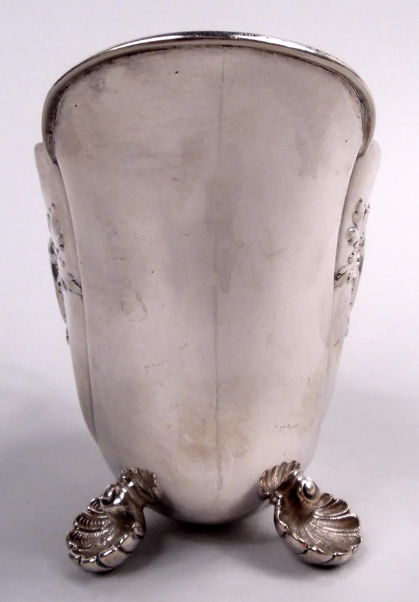 German Rococo 800 silver creamer, ca 1910. Ovoid bowl with asymmetrical mouth; high-looping double scroll handle with leaf cap and beading and three scallop shell supports. Chased leafing scrollwork and two asymmetrical frames of which one vacant