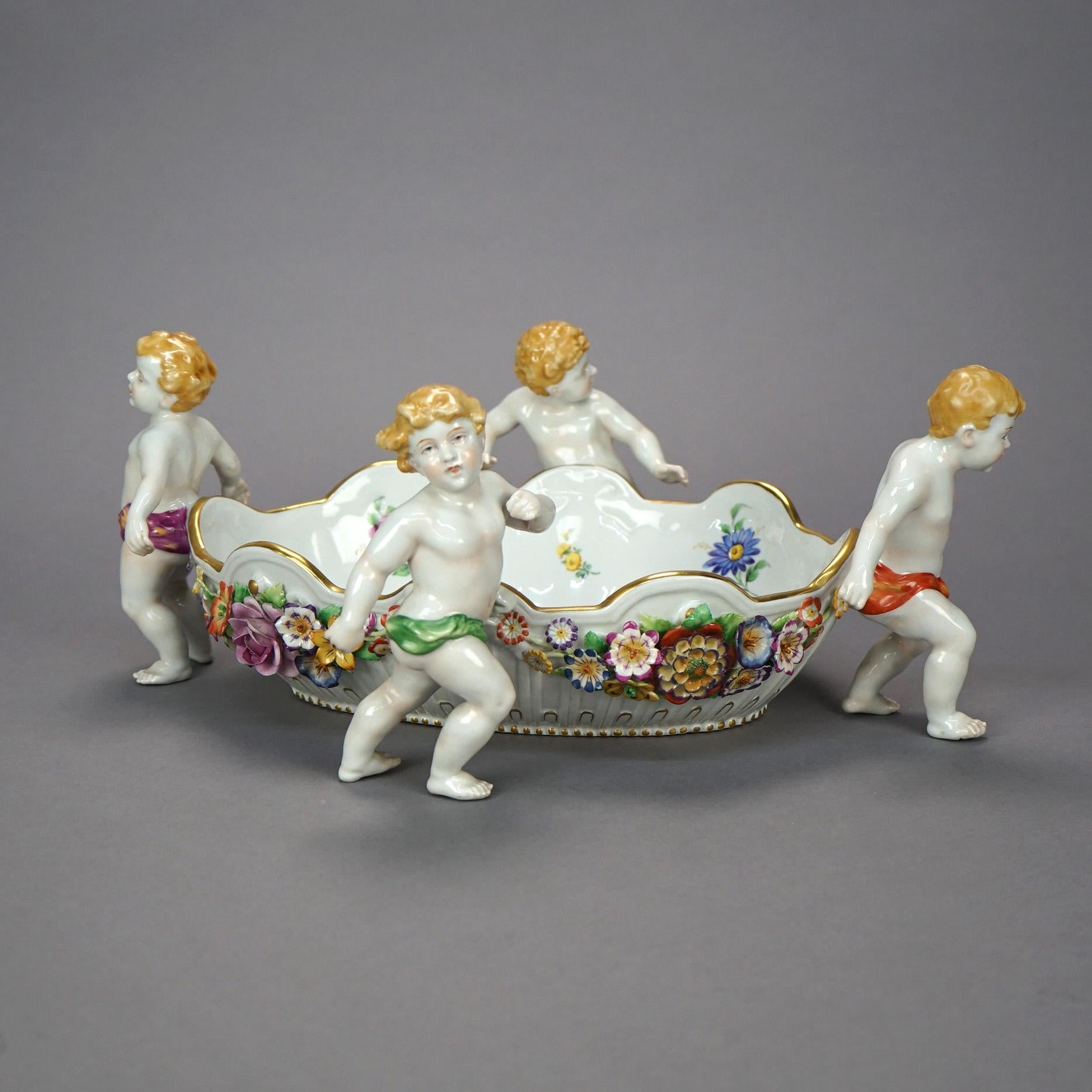 An antique German figural center bowl by Schierholz offers porcelain construction with cherubs and applied flowers throughout, hand painted and with gilt highlights, maker mark on base as photographed, circa 1910.

Measures- 6.5''H x 16.5''W x