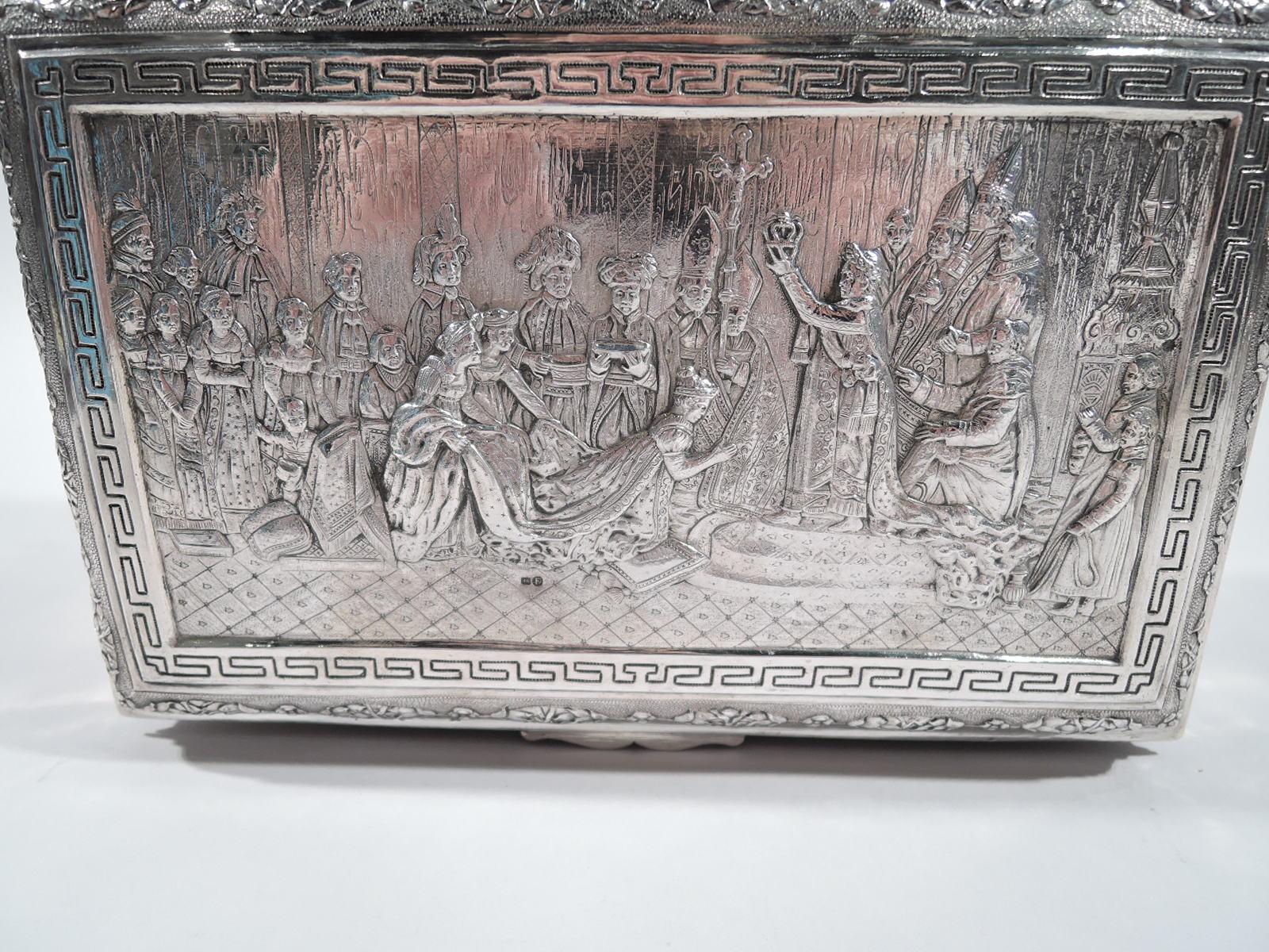 German 930 silver box with scenes of Napoleon’s life. Imported to England in 1900 by Samuel Boaz Landeck in Sheffield. Rectangular with corner leaf-and-scroll mounted claw-and-ball feet. Cover hinged and raised with iconic image of Napoleon famously