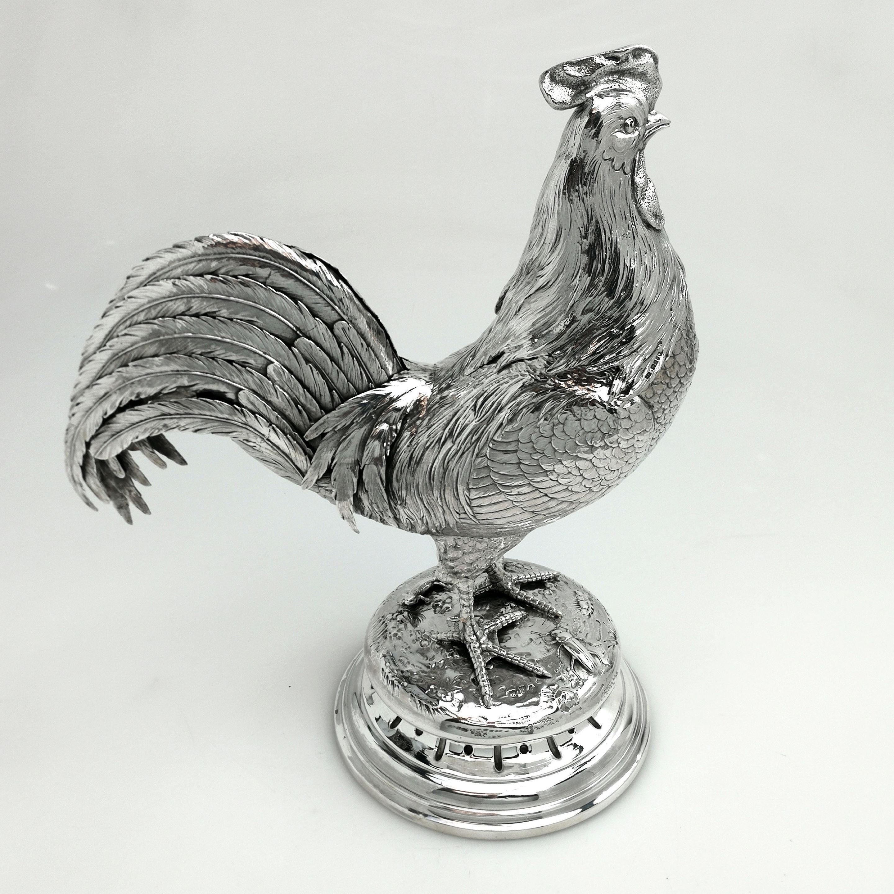 A magnificent antique German sterling Silver Rooster / Cock Figure. This Cockerel stands proudly on a solid silver base with a little lizard and an insect at its feet. The Rooster has impressive tail feathers and is modelled with an excellent