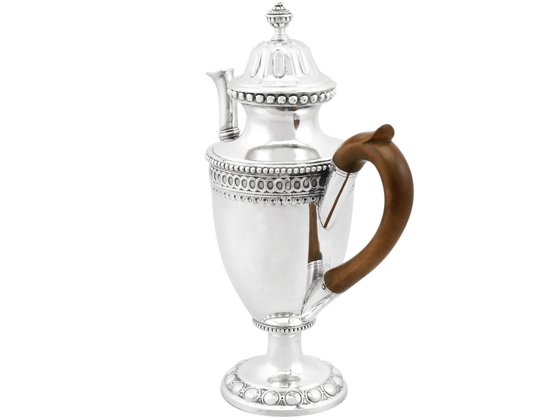 An exceptional, fine and impressive antique German silver coffee pot; an addition to our 18th century silver teaware collection.

This exceptional antique German silver coffee pot has a circular rounded form onto a circular pedestal foot.

The