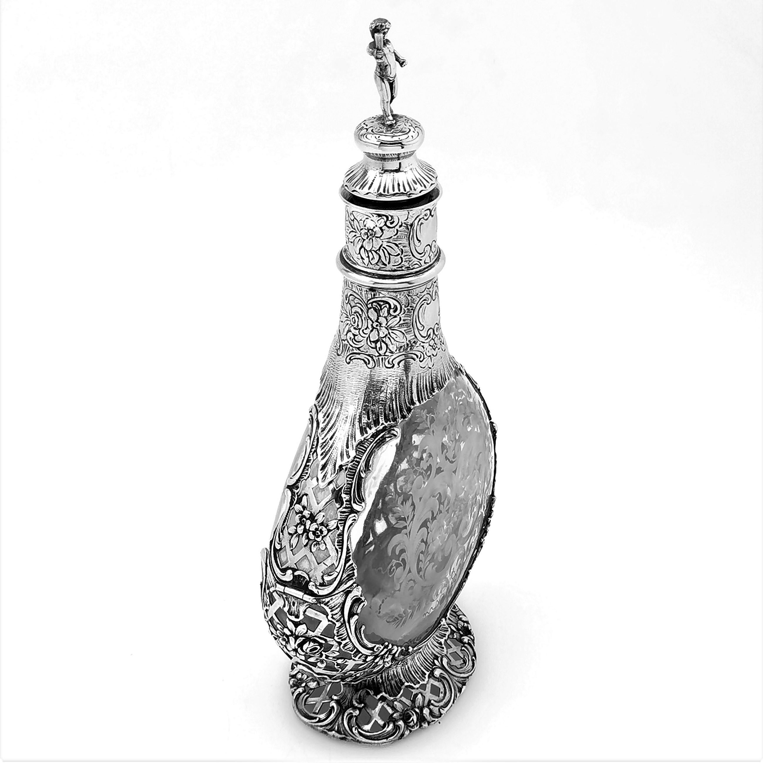 A beautiful antique German silver mounted decanter with an etched glass body. The Decanter has a beautiful chased and pieced Silver Mount with images of flowers and scrolls. The glass body has gorgeous floral and scroll etched patterning