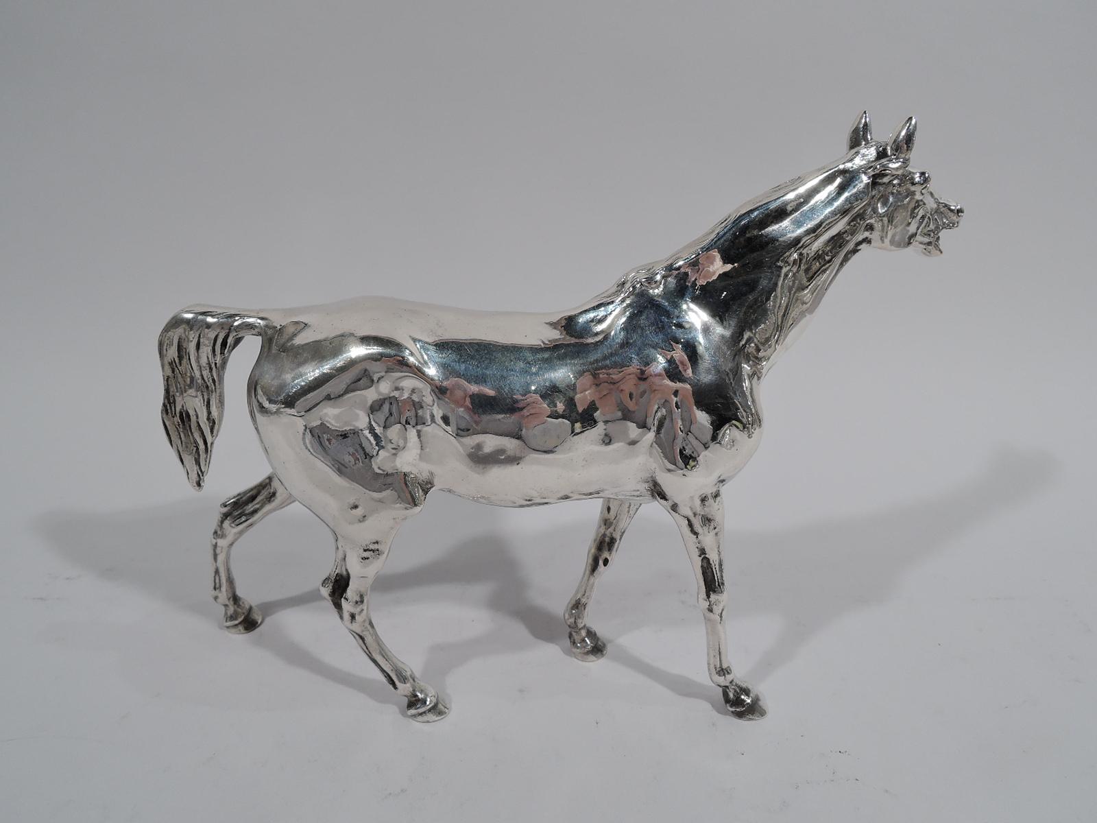 German 800 silver horse figure, circa 1910. An elegant animal with taut, muscular body, sturdy legs, and groomed mane and tail. Alert expression with erect ears and gaping mouth. Marked on hoof. Weight: 16 troy ounces.