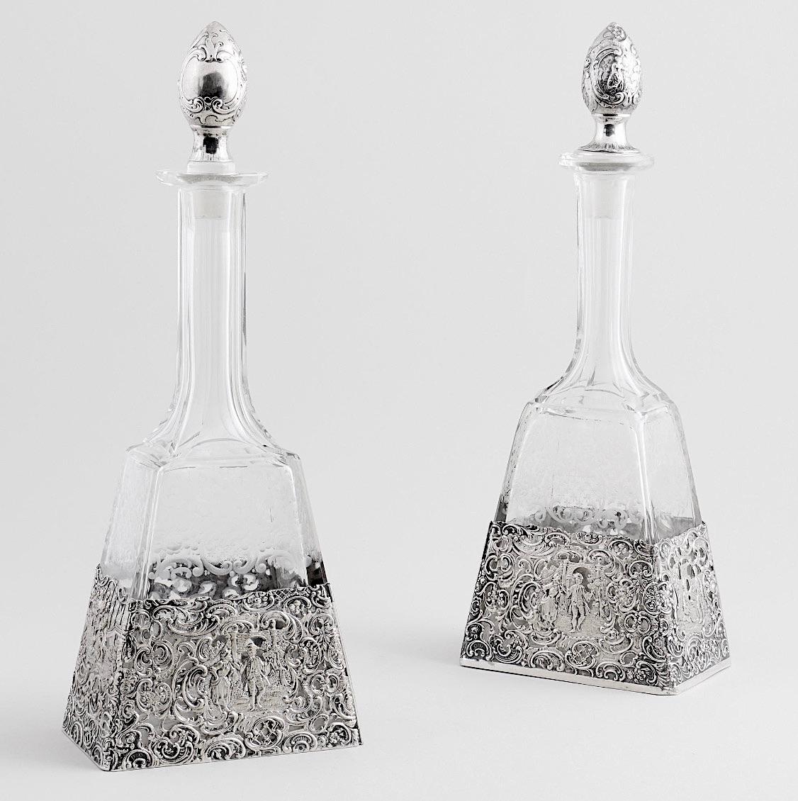 Este exquisito par de decantadores antiguos alemanes, procedentes de Hanau, muestra una artesanía excepcional y una elegancia atemporal. Estos decantadores, perfectos como servicio de mesa o de bar, son una armoniosa mezcla de vidrio grabado y una