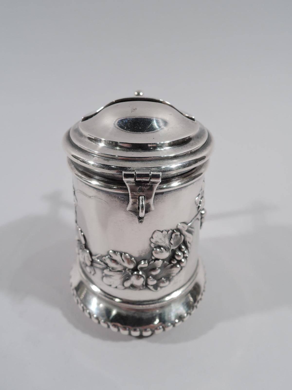 Turn of the century German 800 silver tzedakah (Jewish charity box). Cylindrical with lobed and bellied bottom and mortise Tenon-style bracket handle. Cover hinged and domed with hasp; top has wide slit with loose rings mounted to interior to