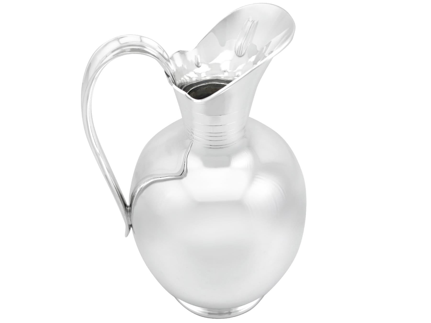 An exceptional, fine and impressive antique German silver cordial/water jug; part of our dining silverware collection

This exceptional antique German silver water jug has a circular rounded form onto a circular spreading foot.

The ovoid-shaped
