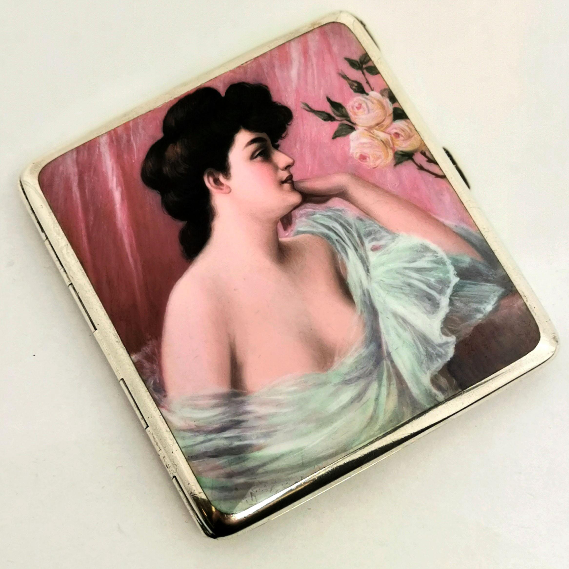 A beautiful antique German solid Silver Cigarette Case with an enamel image on the front cover. This image shows a woman gazing at three lush pink roses with her translucent gown draped low over her chest. The back cover is plain polished silver and