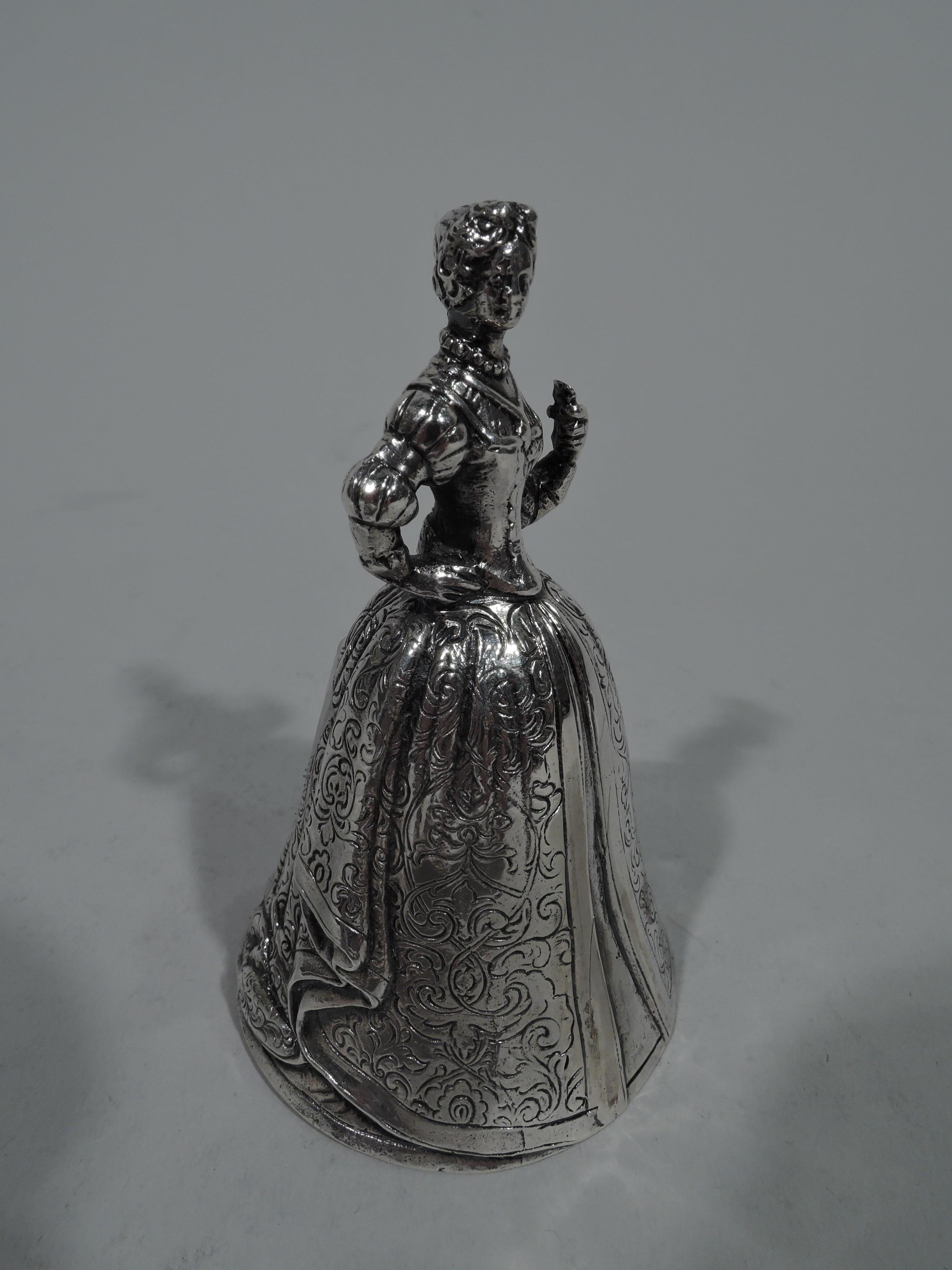 German sterling silver figural bell. Imported to England in 1907. An olden-days lady in a wide sweeping skirt with tooled pattern and snug bodice stands with one hand on hip. Clapper makes nice ring. A pretty belle bell. German marks and English