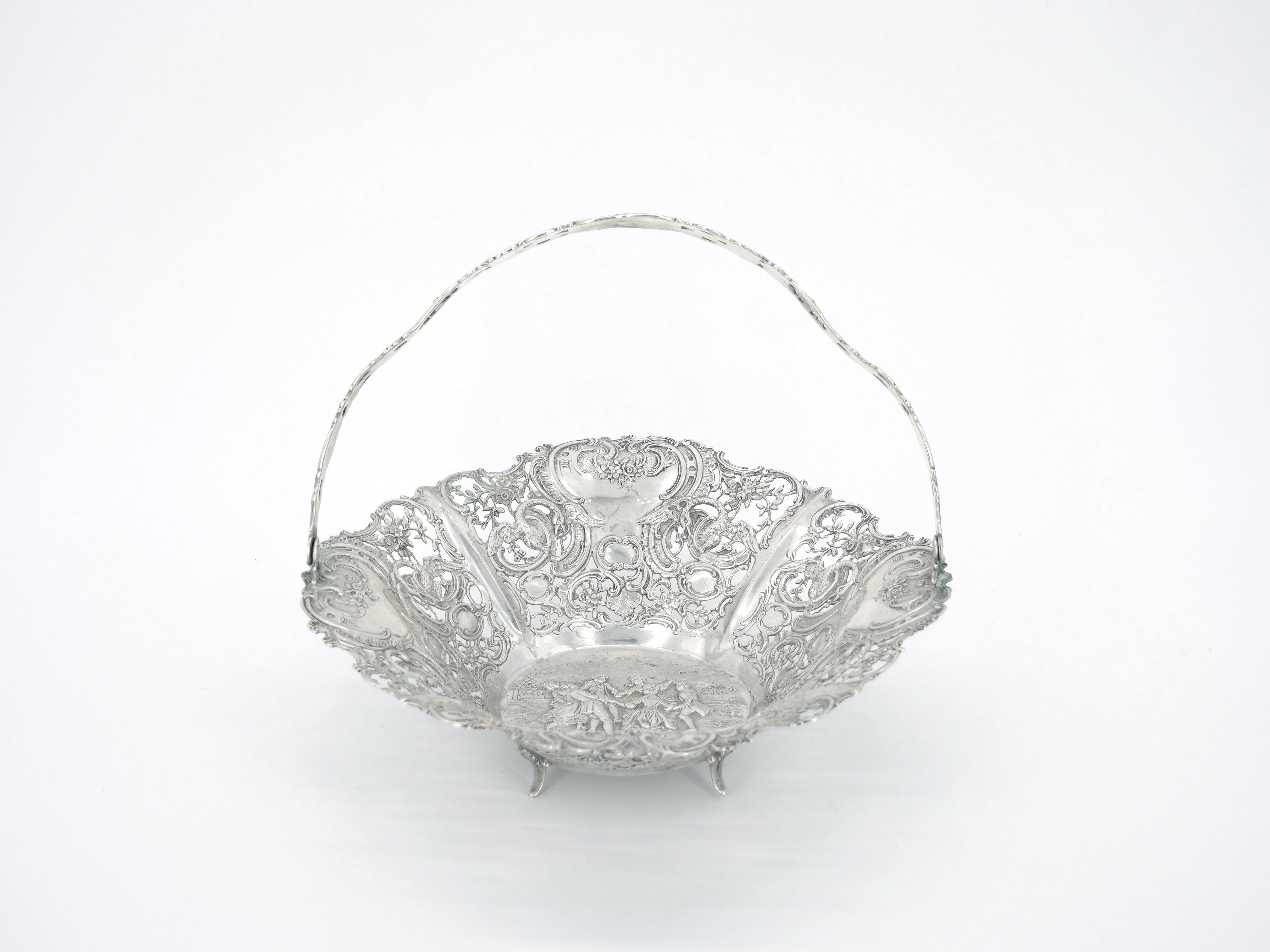 
Experience the extraordinary craftsmanship of the early 19th century with our magnificent German sterling silver basket. This captivating piece showcase an exquisitely ornate all-over hand-engraved design that is truly a work of art. Immerse