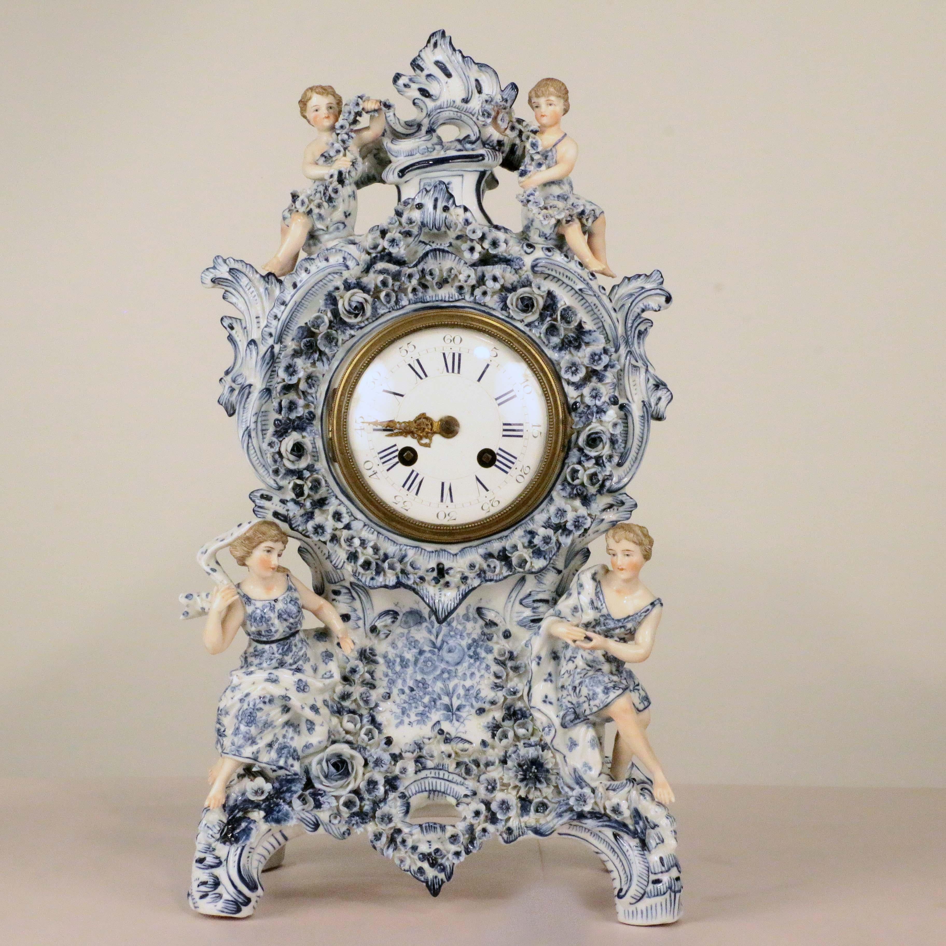 For those who enjoy the fine quality of blue and white German porcelain from the middle of the last century, this is a particularly fine example. On a white porcelain ground, hand-painted and applied with leaves and flowers, the clockcase and