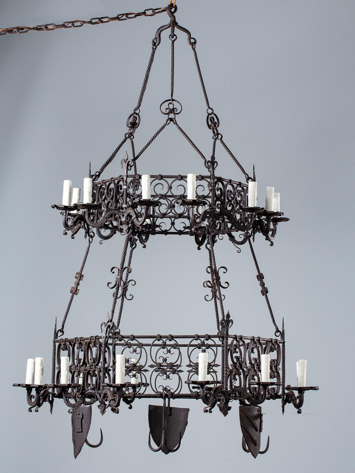 A spectacular antique German forged iron chandelier from a Bavarian Festhalle circa 1880. Please notice the two tiers which feature 24 lights between the two levels. The chandelier has six sides to form a hexagon and the base of the chandelier has