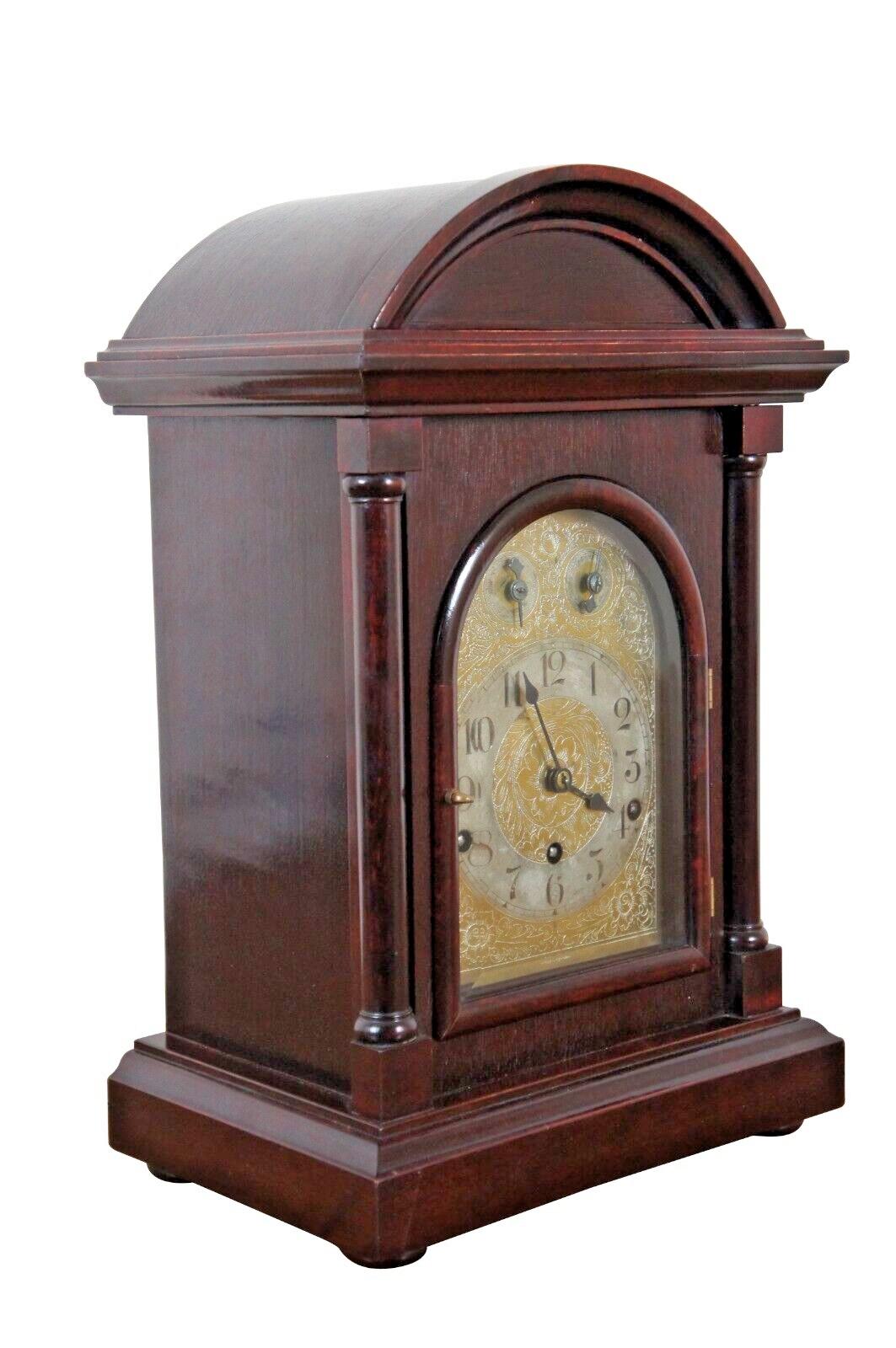 Early 20th Century Kienzle key wound mantel clock with simple neoclassical mahogany case and floral etched brass face including controls for speed and chime above the clockface. Arabic numerals. Westminster chimes. Works numbered 60782. Made in