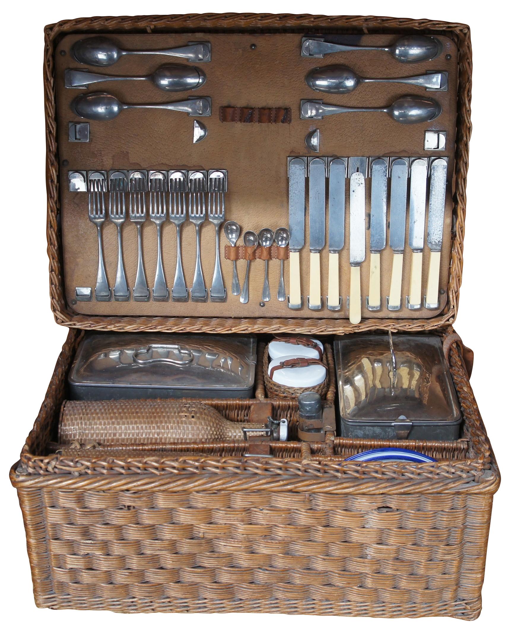 A lovely European Picnic set. Originally serviced 8. Includes Forks, spoons, knives, glass bottles, enamelware plates, drinking glasses, sandwich tins, bottle and can openers. Features an elaborate woven rattan case with compartments for storage.