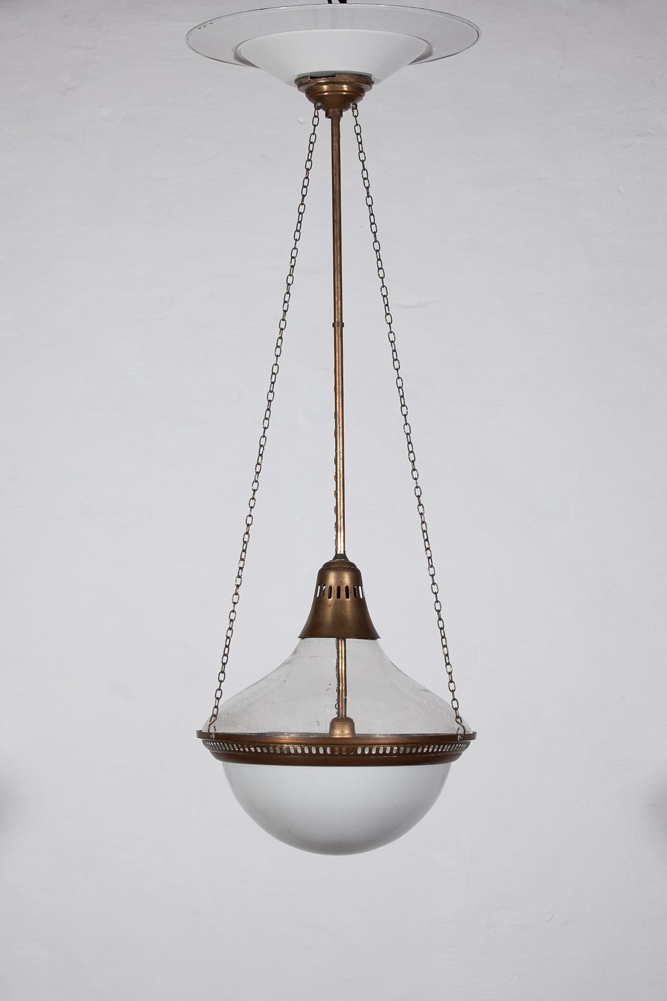 The large antique hanging lamp was designed for Siemens. The lamp is complete original with a nice combination of a clear glass upper shade and a frosted glass lower shade. All metal parts are complete and original. The lamp is in good vintage