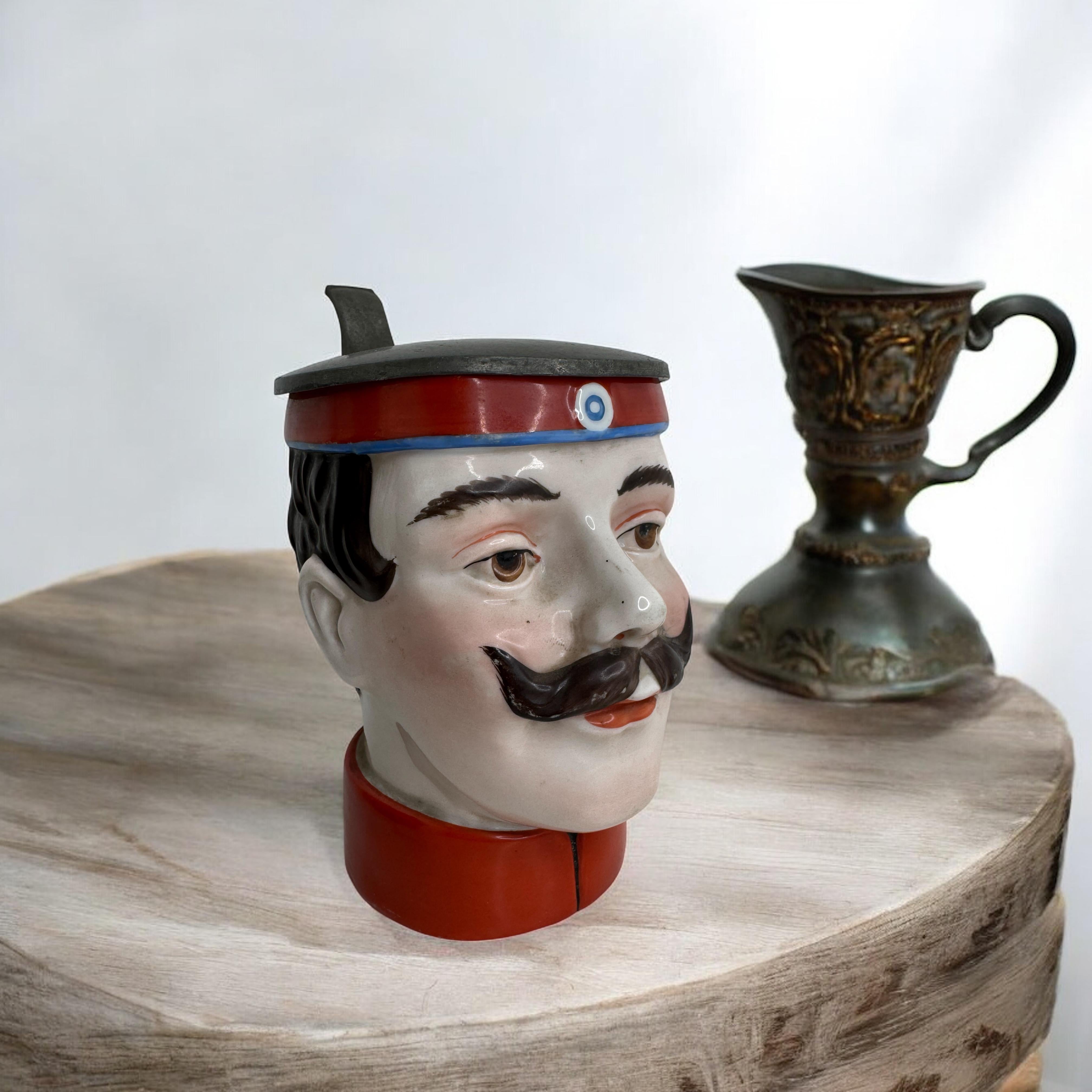 A gorgeous character beer stein - Soldier Head. This character beer stein has been made in Germany about 1900s or older, attributed to E. Bohne, Thuringia Germany. Absolutely gorgeous piece hand painted and still in great condition. Lid works