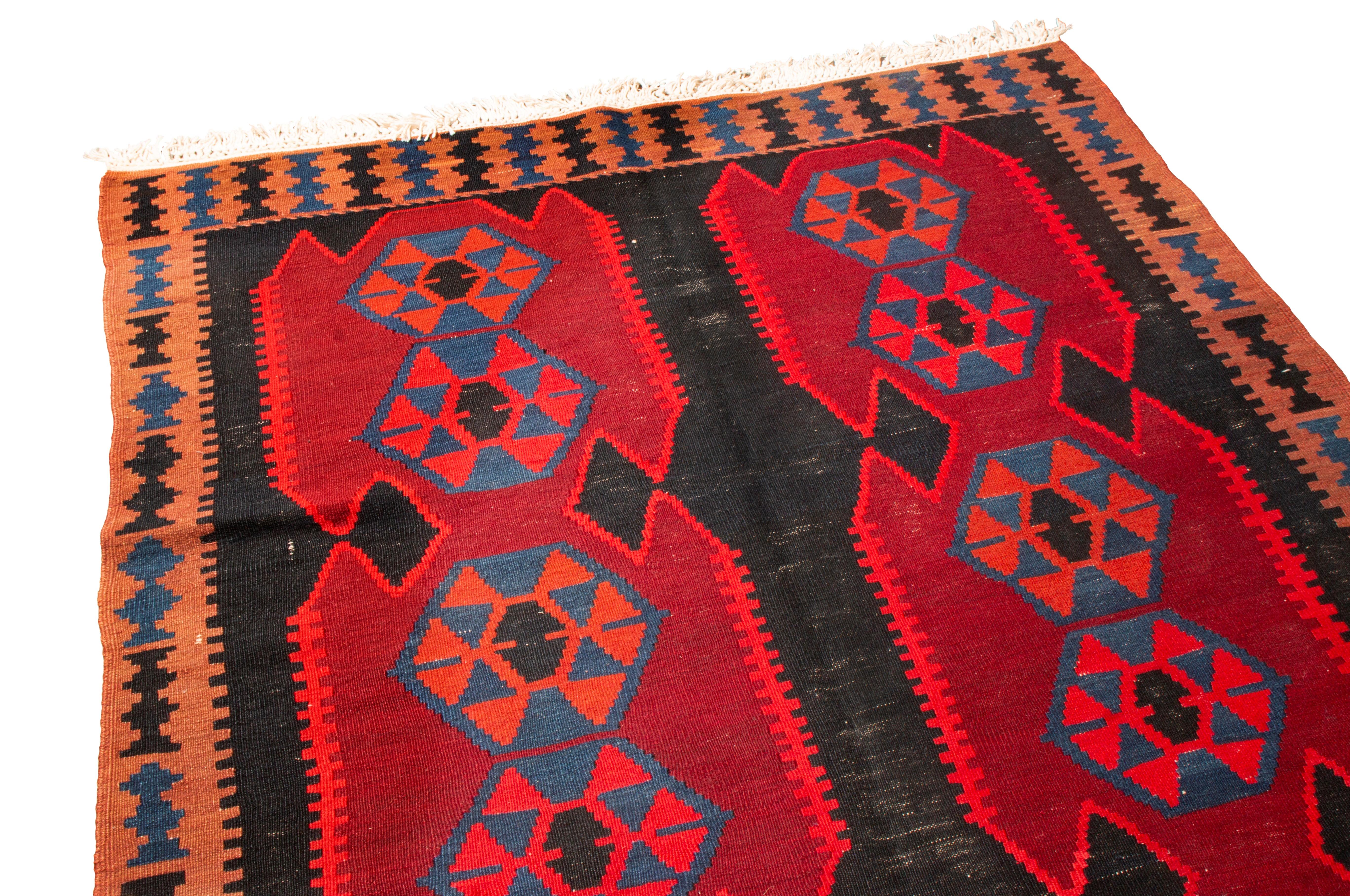Originating from Persia in 1920, this antique Persian kilim rug from Rug & Kilim embodies the Ghazvin (Qazvin) field design, with lesser-known geometric scorpion symbols throughout the field design to promote awareness and ward off evil. As Ghazvin