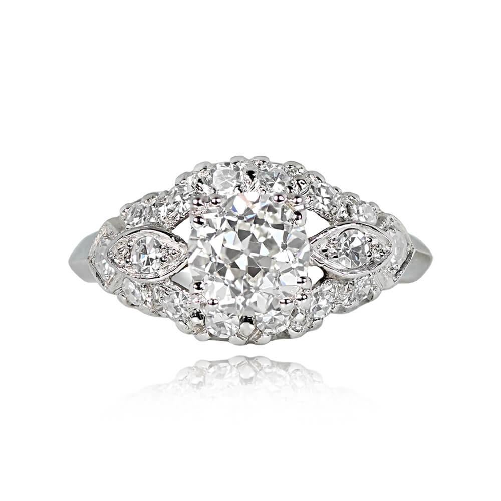 An Art Deco engagement ring showcasing a 1.27-carat old European cut diamond, K color, and VS2 clarity, set in box prongs. Marquise-shaped bezels with single-cut diamonds flank the center stone, and an outer halo of additional single-cut diamonds