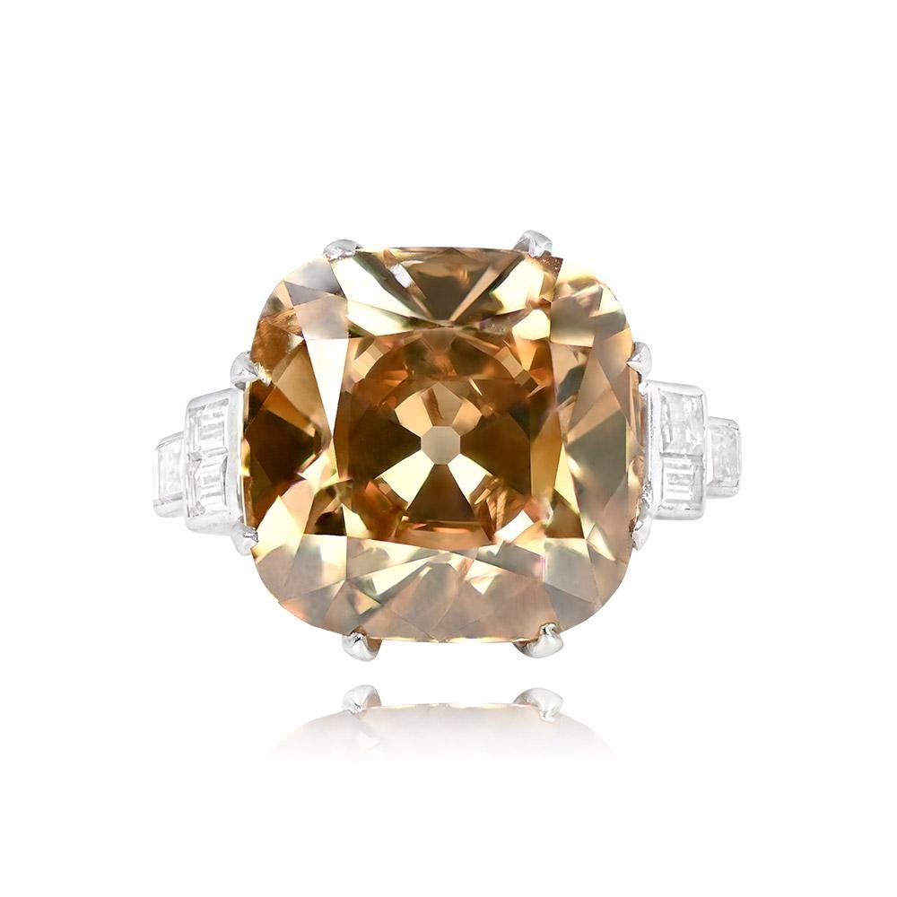 A ring showcasing a GIA-certified 13.03 carat Fancy Dark Yellowish-Brown antique cushion cut diamond, set with prongs. Geometric designs of three baguette-cut diamonds embellish each shoulder. The total weight of the baguette-cut diamonds is