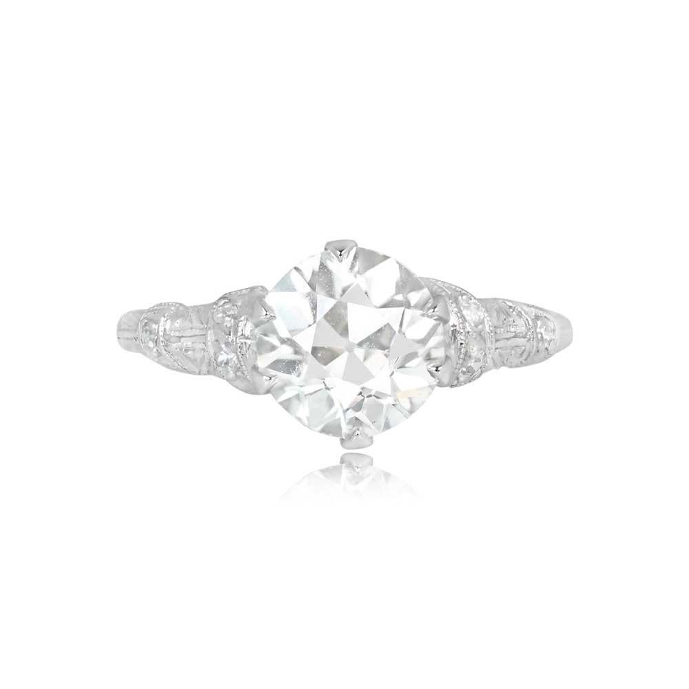 A vintage Art Deco engagement ring showcases a GIA-certified 1.65-carat old European cut diamond, J color, and VS2 clarity. The center diamond is elegantly prong-set in platinum. The ring's platinum mounting features intricate hand engravings and is