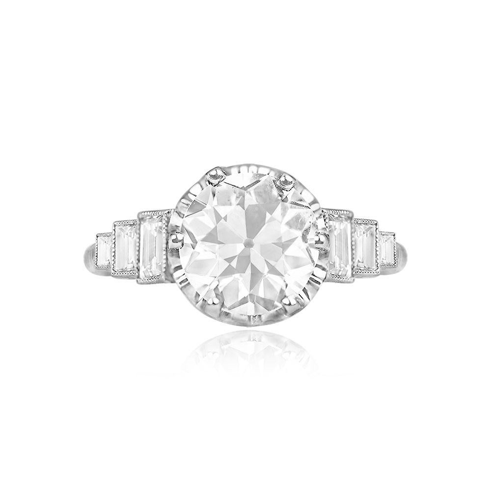 Exquisite antique platinum ring crafted during the Art Deco era. Highlighted by a vibrant, GIA-certified old European cut diamond weighing 1.83 carats (K color, SI1 clarity), prong-set for brilliance. The shoulders are adorned with three bezel-set