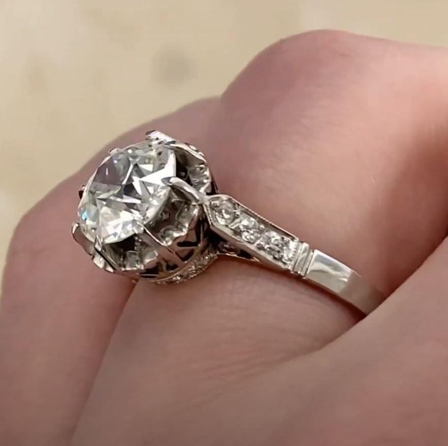 This exquisite Art Deco-era ring, circa 1920, showcases timeless elegance and masterful craftsmanship. At its heart is a dazzling 2.32-carat old European cut diamond, GIA-certified with a J color and SI2 clarity, secured in delicate prongs. This