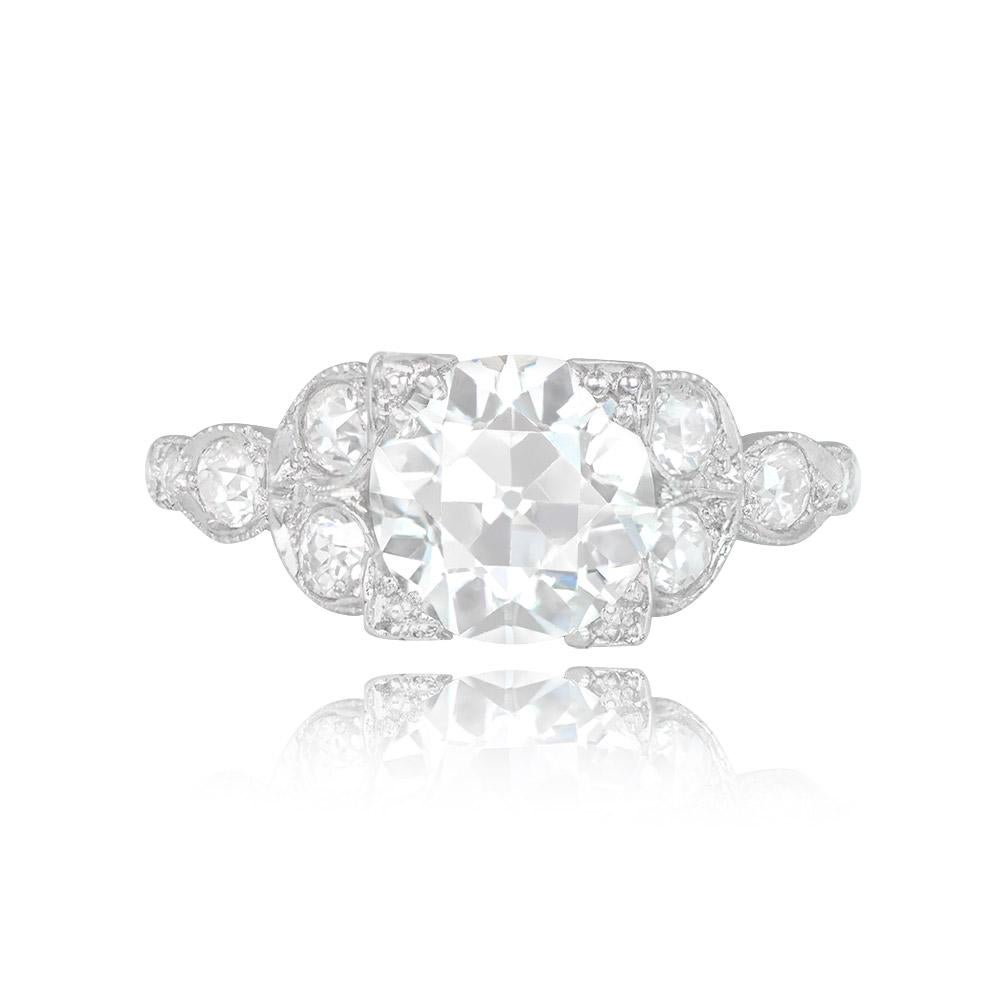 This antique ring features a GIA-certified 2.64-carat old European cut diamond with K color and VS1 clarity, set in box prongs. The shoulders are intricately adorned with a diamond-set leaf motif and delicate milgrain detailing. The side diamonds