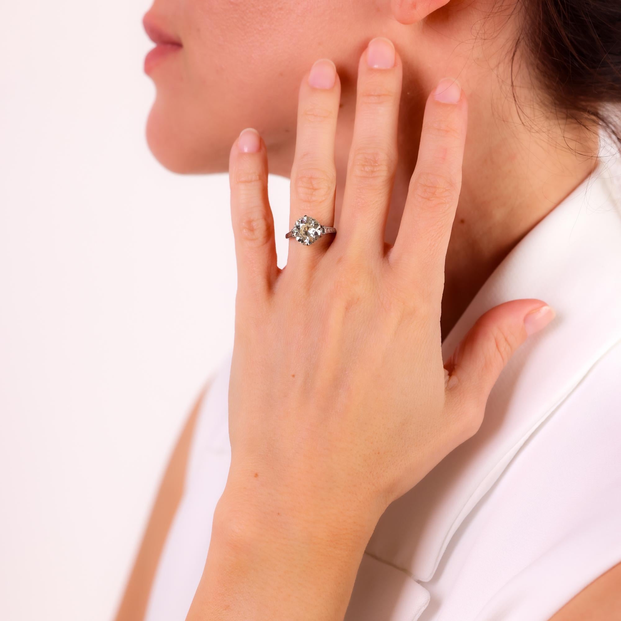 This antique engagement ring boasts a dazzling 2.88 carat old European cut diamond, certified by GIA, set in elegant 9k white gold.

Certificate: GIA #1232456165
Center stone: Old European cut diamond
Weight: 2.88 carat
Color: N
Clarity: SI1
Metal: