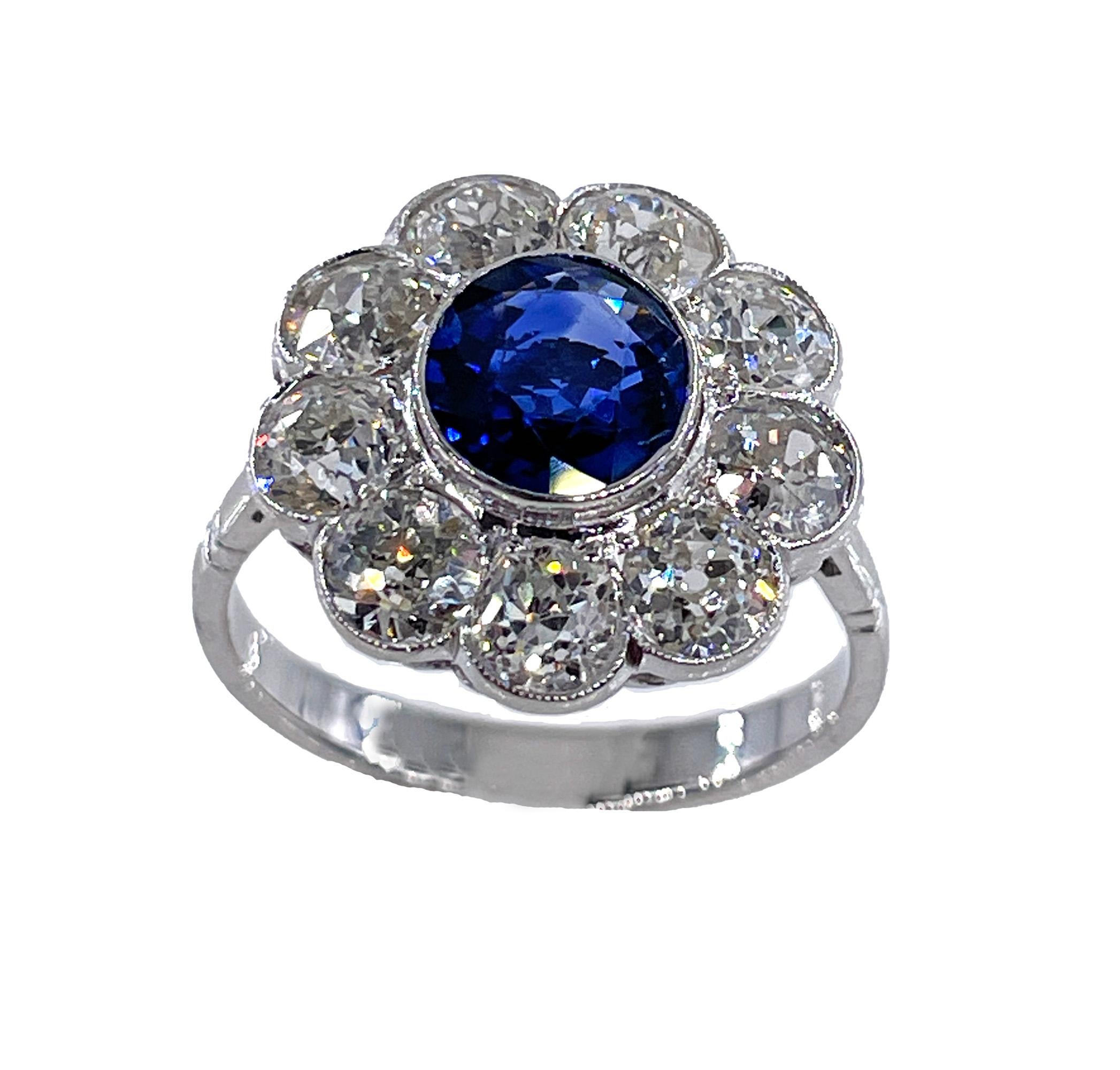 1900s Antique European-made GIA 5.20ctw Old European Ceylon Sapphire & Diamond Cluster Blossom Flower 18K White Gold Ring.
This ring is so bright and lively that it's difficult to keep your eyes off of it, even in the dark! By daylight, by