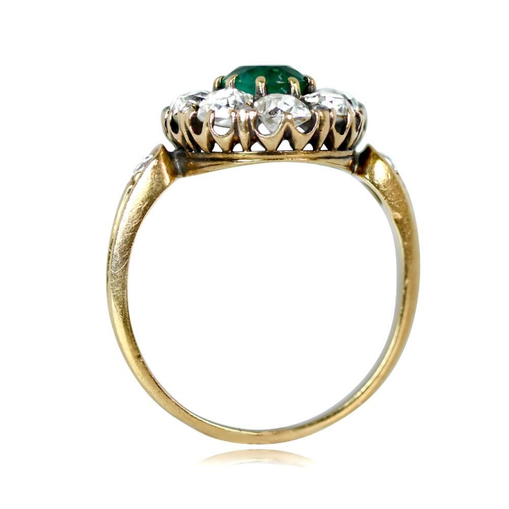 This exquisite Victorian emerald ring boasts a GIA-certified Colombian emerald weighing about 1 carat, surrounded by a cluster of old mine-cut diamonds. The antique ring, handcrafted in the early 1880s, exudes a charming allure and is fashioned from