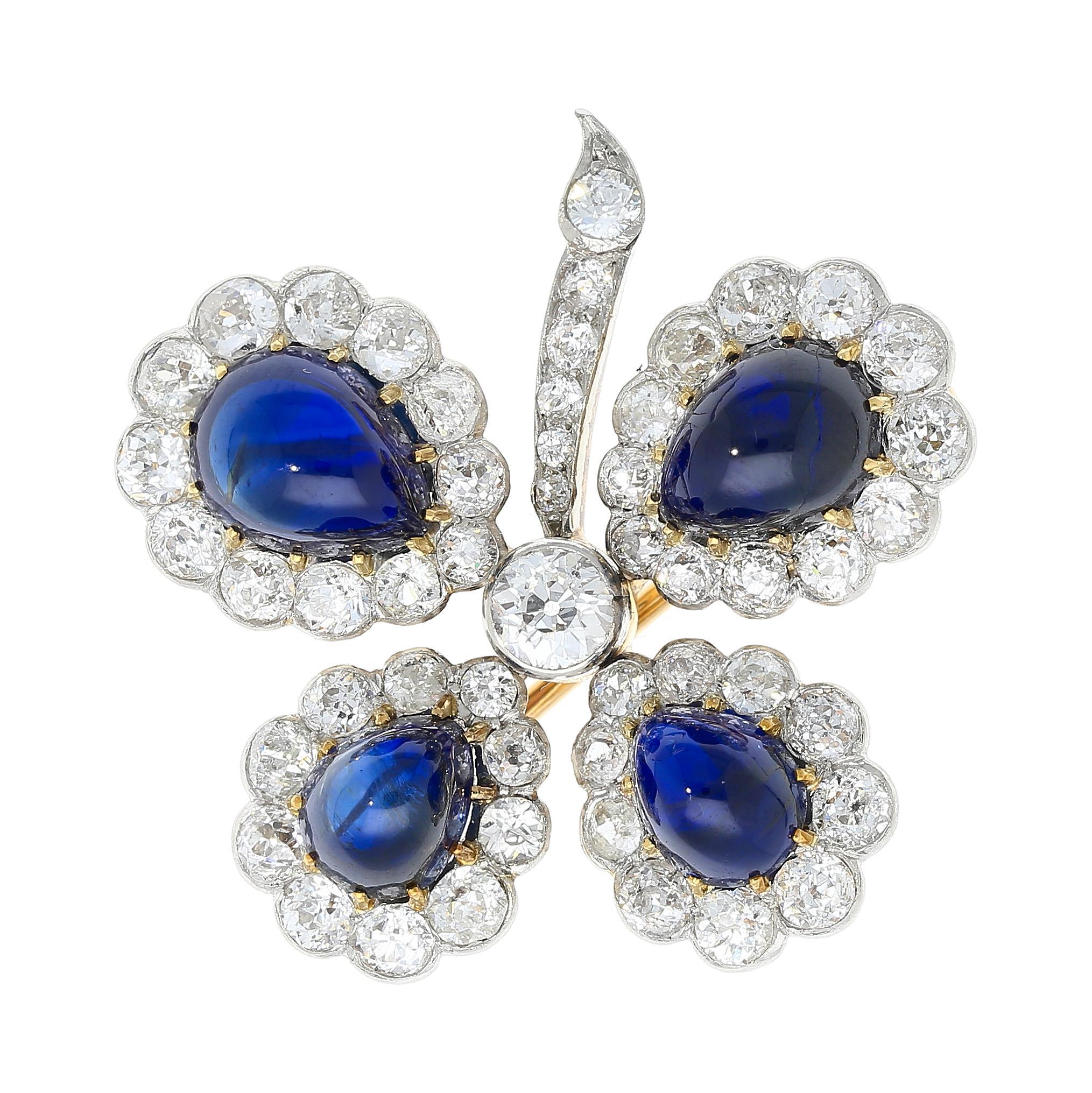 Antique GIA Certified 6 Carat Total Cabochon-Cut Blue Sapphire and Round Cut Diamond Halo Floral Brooch. Circa 1920. Set with all natural gemstones with platinum and 18k gold. 11 carats total.

Details: 
Item Type: Brooch
Metal: 18K Yellow Gold,