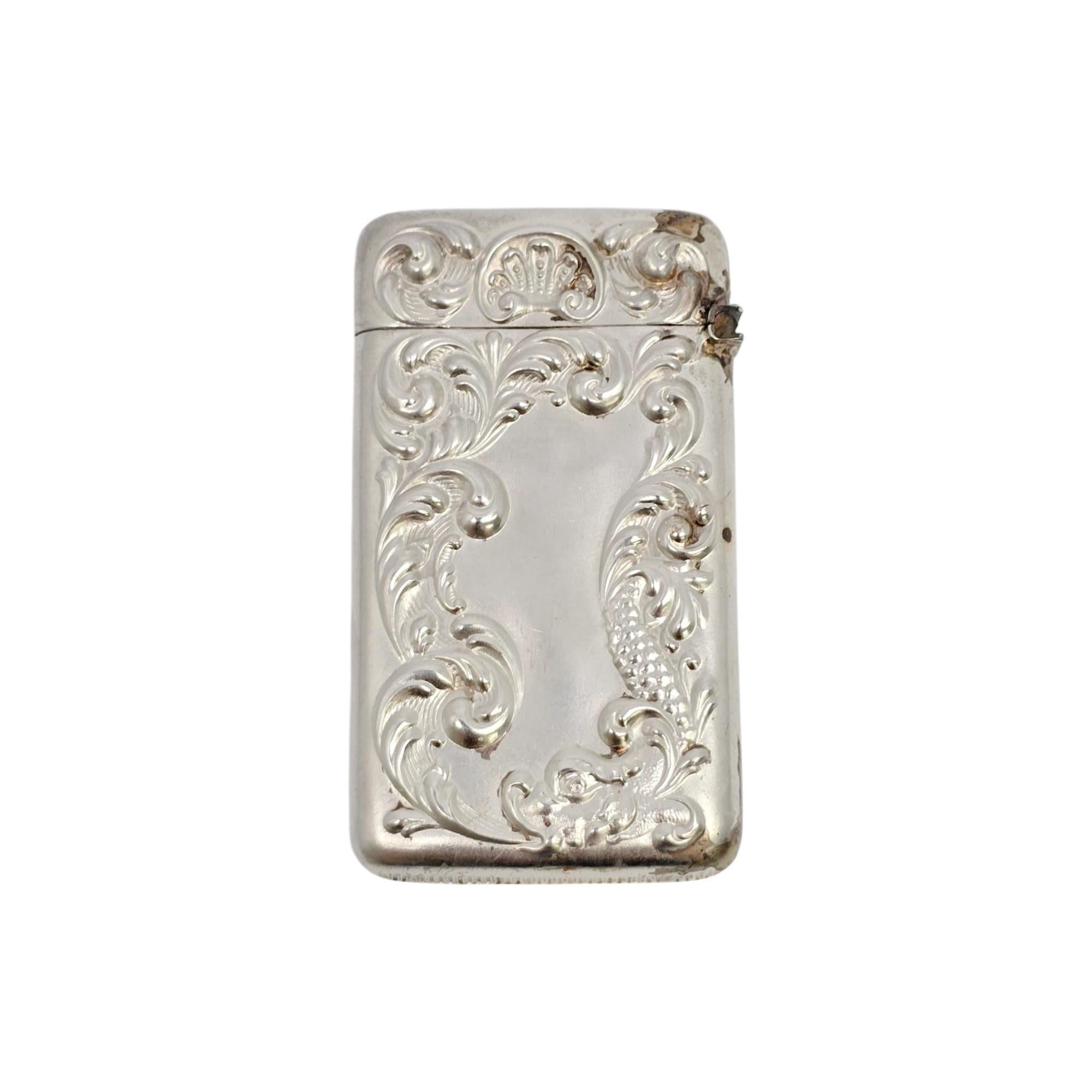 Antique sterling silver match safe/vesta case by F.S Gilbert & Co, with monogram.

Monogram appears to be GHH

This beautifully repoussed piece features an Art Nouveau design of scrolls and a dragon, circa 1890. Monogram on one side.

Measures