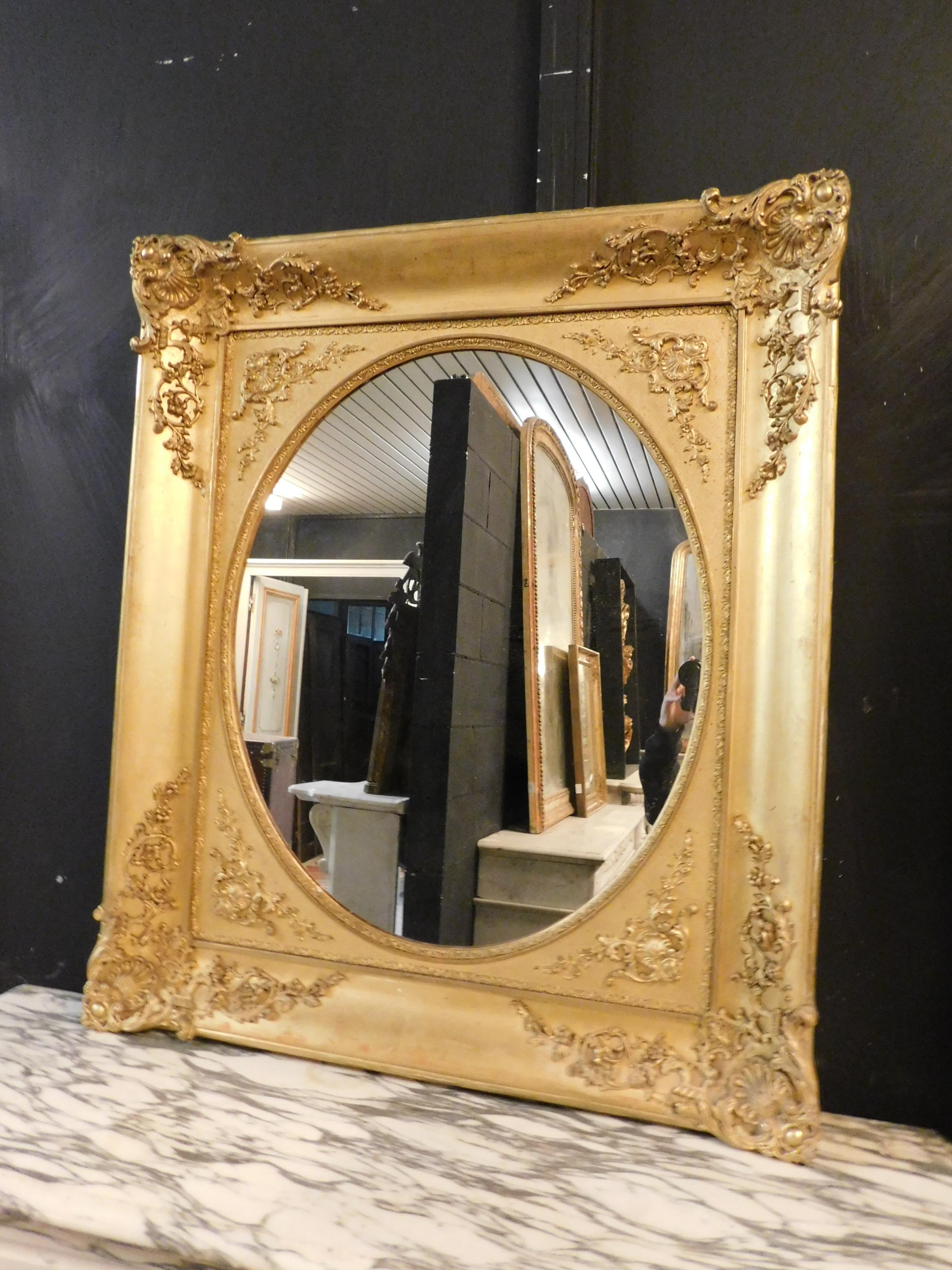 Antique golden mirror, richly carved by hand with beautiful details in the frame, rectangular in shape but with oval mirror, from the 19th century, from Piedmont (Italy), ideal to be installed in many environments such as entrances, offices,
