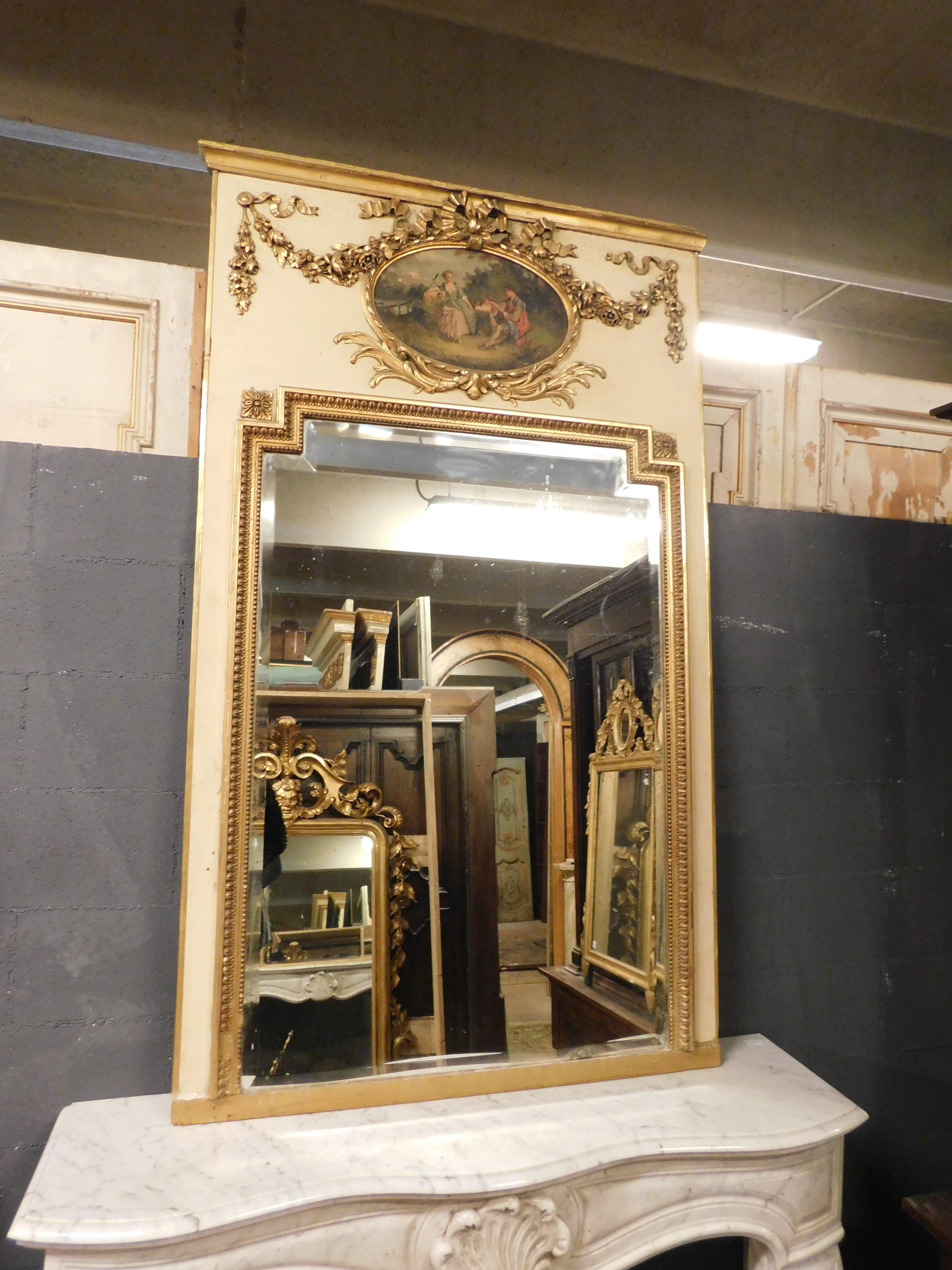 Antique gilded and hand-lacquered mirror, with painting depicting a scene in nature in the countryside, decorated with sculpted and gilded festoons, impressive original mirror, striking that surrounds the entire mirror. From the 19th century, coming