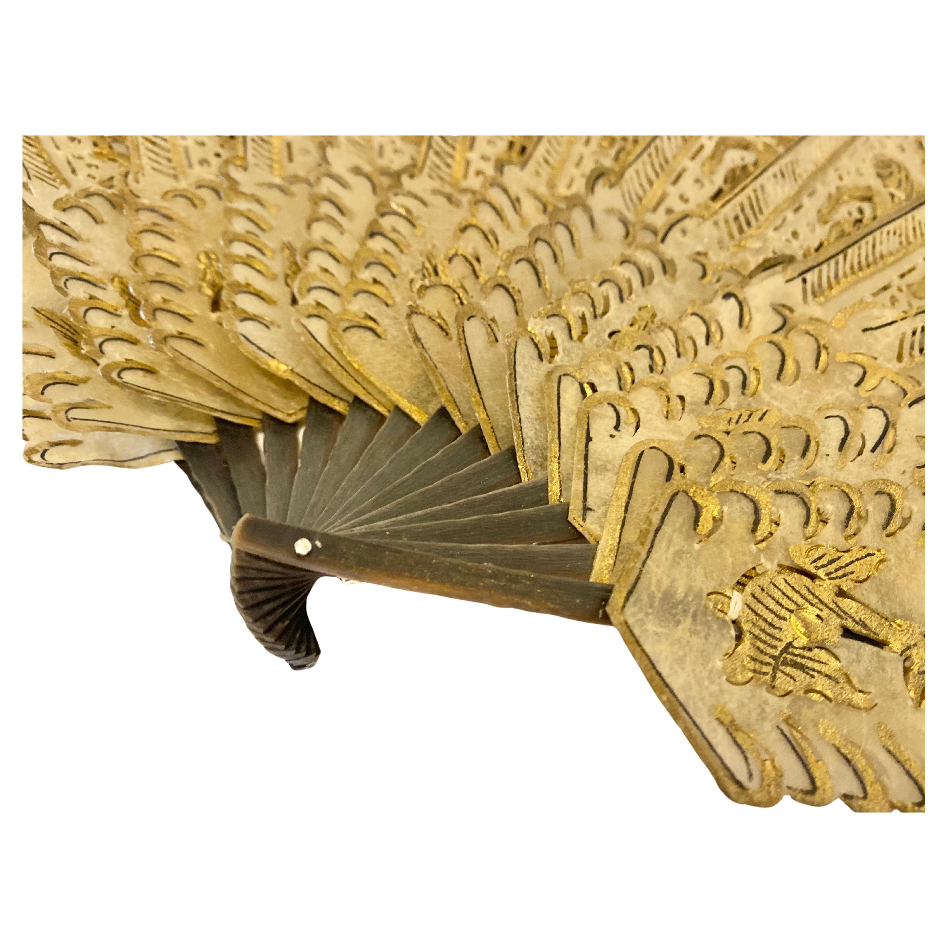 Antique Gilded Brisé Fan  Pierced Celluloid Hand Fan with Gold Painted Figures  Late 19th / Early 20th Century
An exquisite antique brisé-style fan featuring pierced celluloid ribs delicately painted with gold figural and floral motifs. Each panel