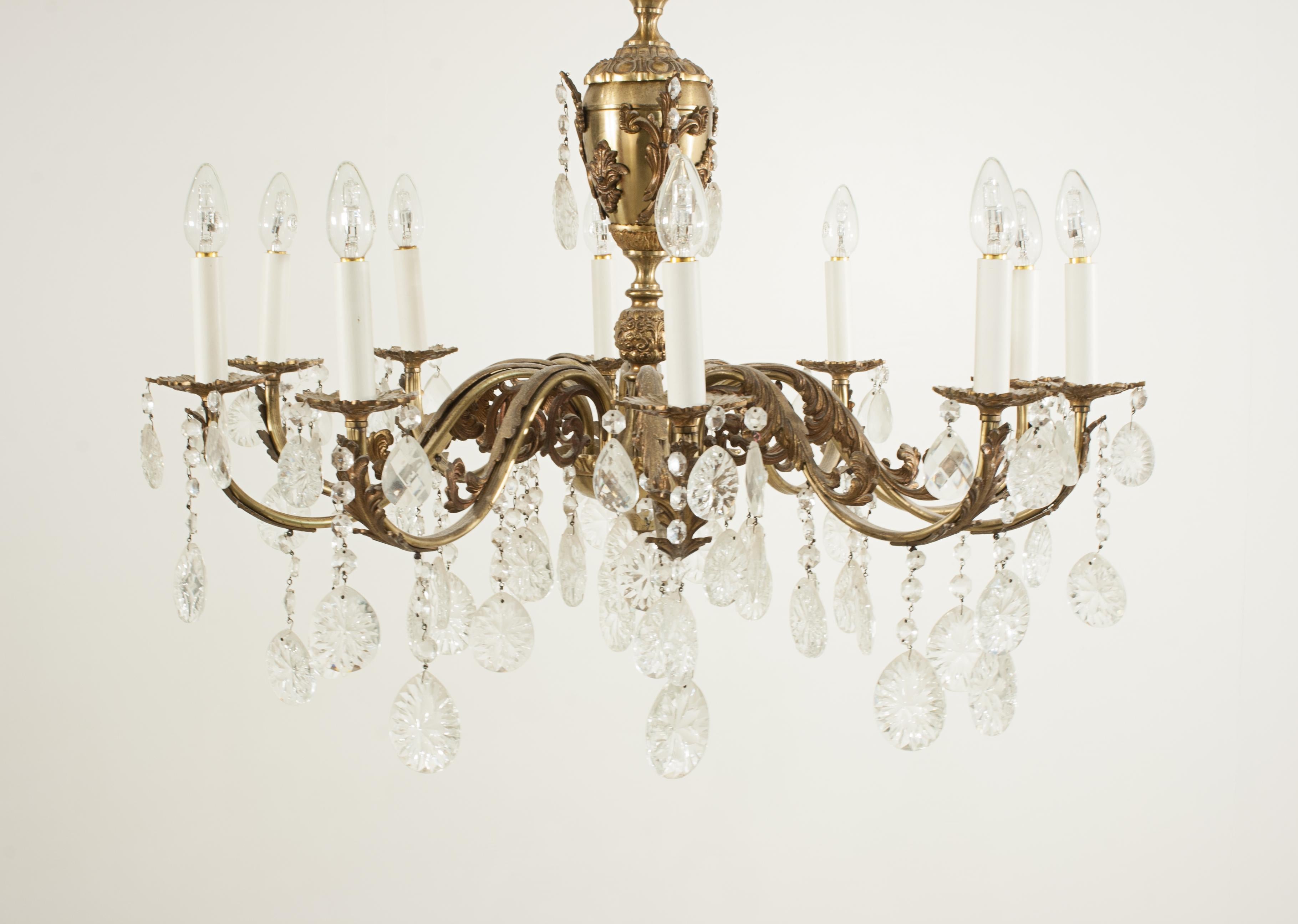 Antique Gilded Crystal Chandelier.
An elegant and beautiful gilt chandelier with intricate foliated detailing and crystal pendants. The chandelier constructed with a main bulbous central body with ten delicate acanthus leaf clad scrolling arms. Each