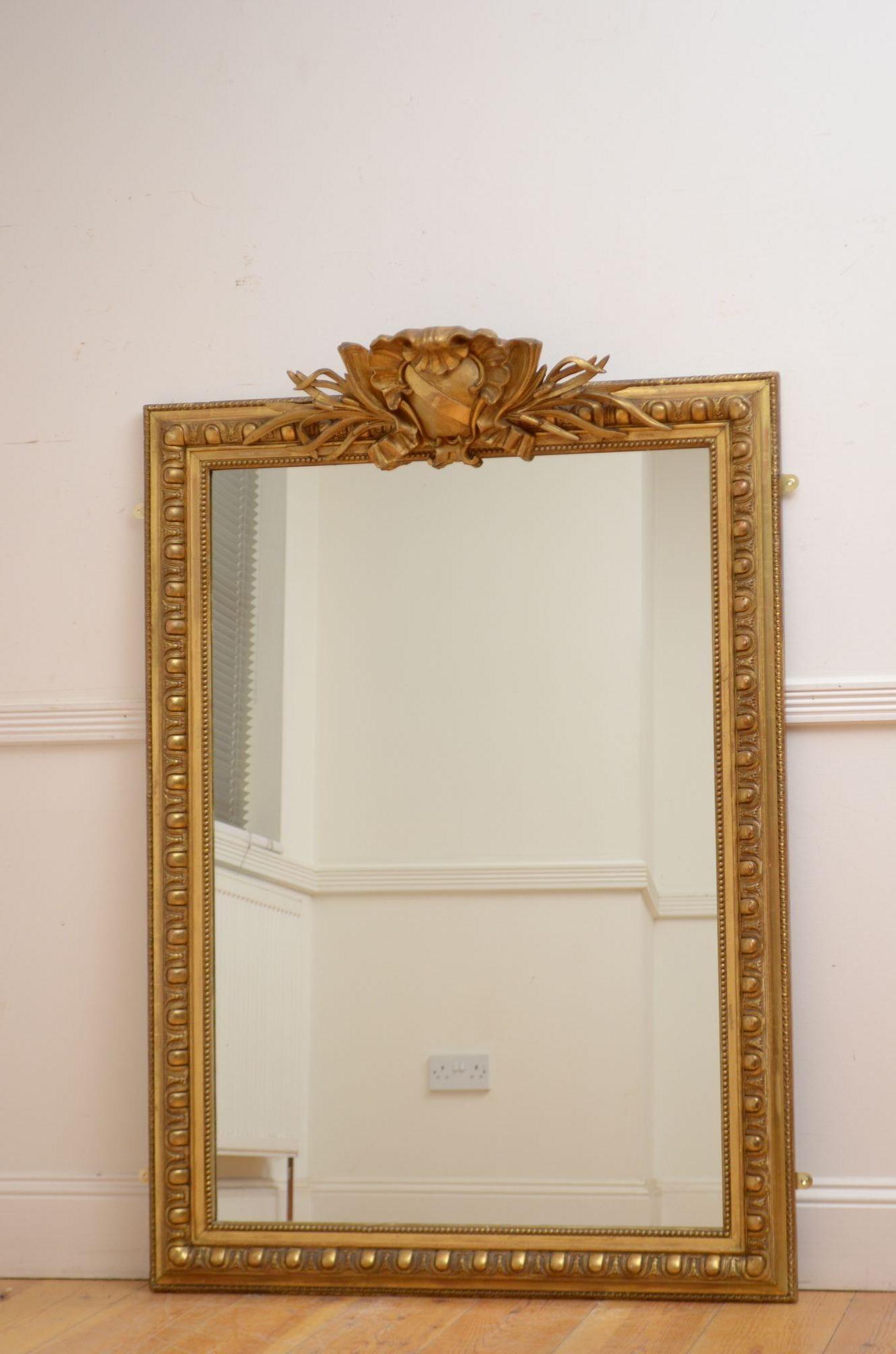 Sn5519 Attraktiver Wandspiegel aus vergoldetem Holz aus dem 19. Jahrhundert mit Ersatzglas in einem perlenbesetzten und vergoldeten Rahmen mit Ei-und-Pfeil-Dekoration und einem großen zentralen Wappen mit Muschel- und Laubblättern. Dieser antike