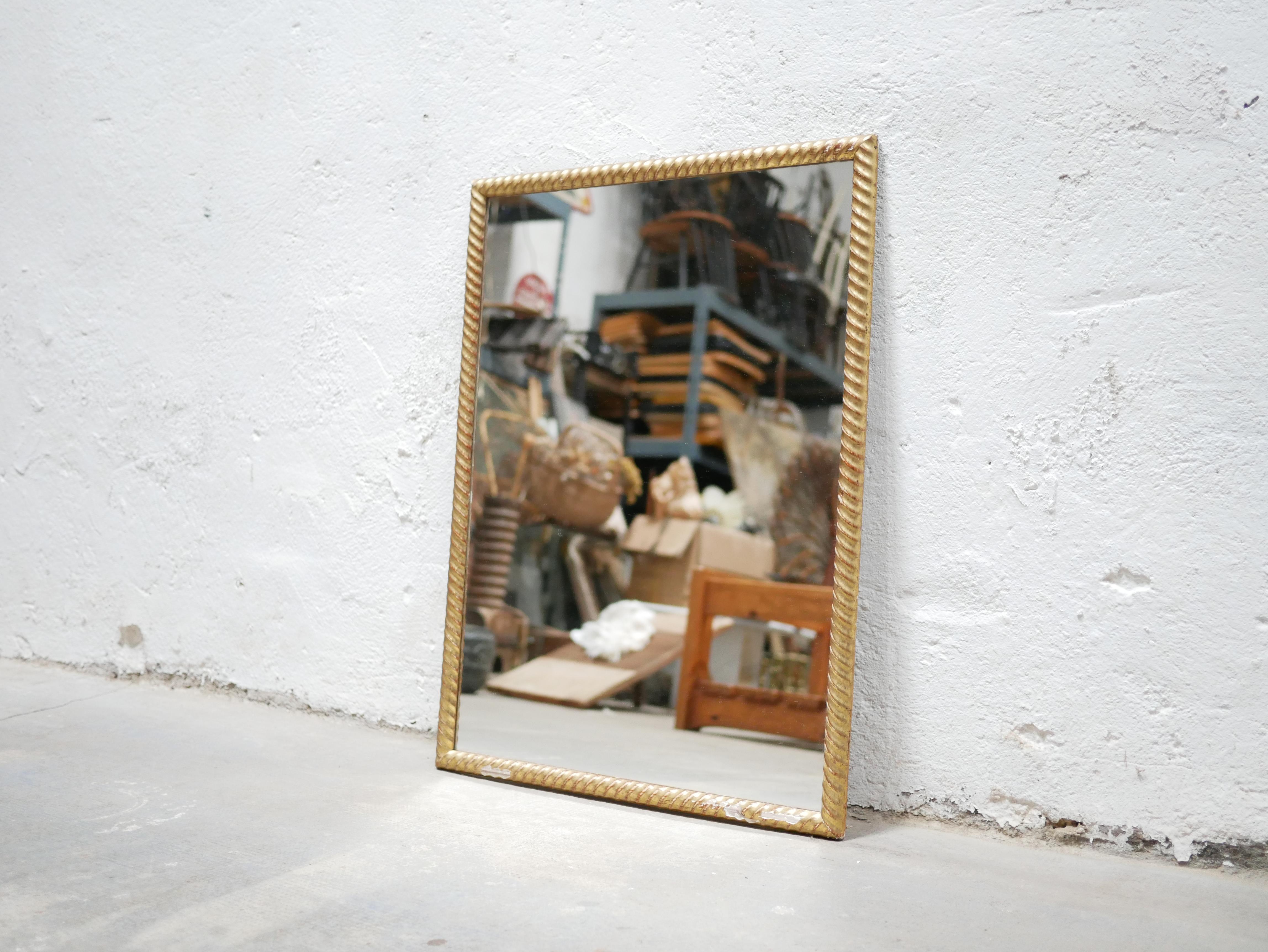 Mirror in wood and gilded stucco, circa 1950.

Beautifully sized, simple and aesthetic, the mirror will be perfect hanging on the wall, in the bathroom, living room or even in the bedroom. A trendy and timeless decorative object for a vintage or