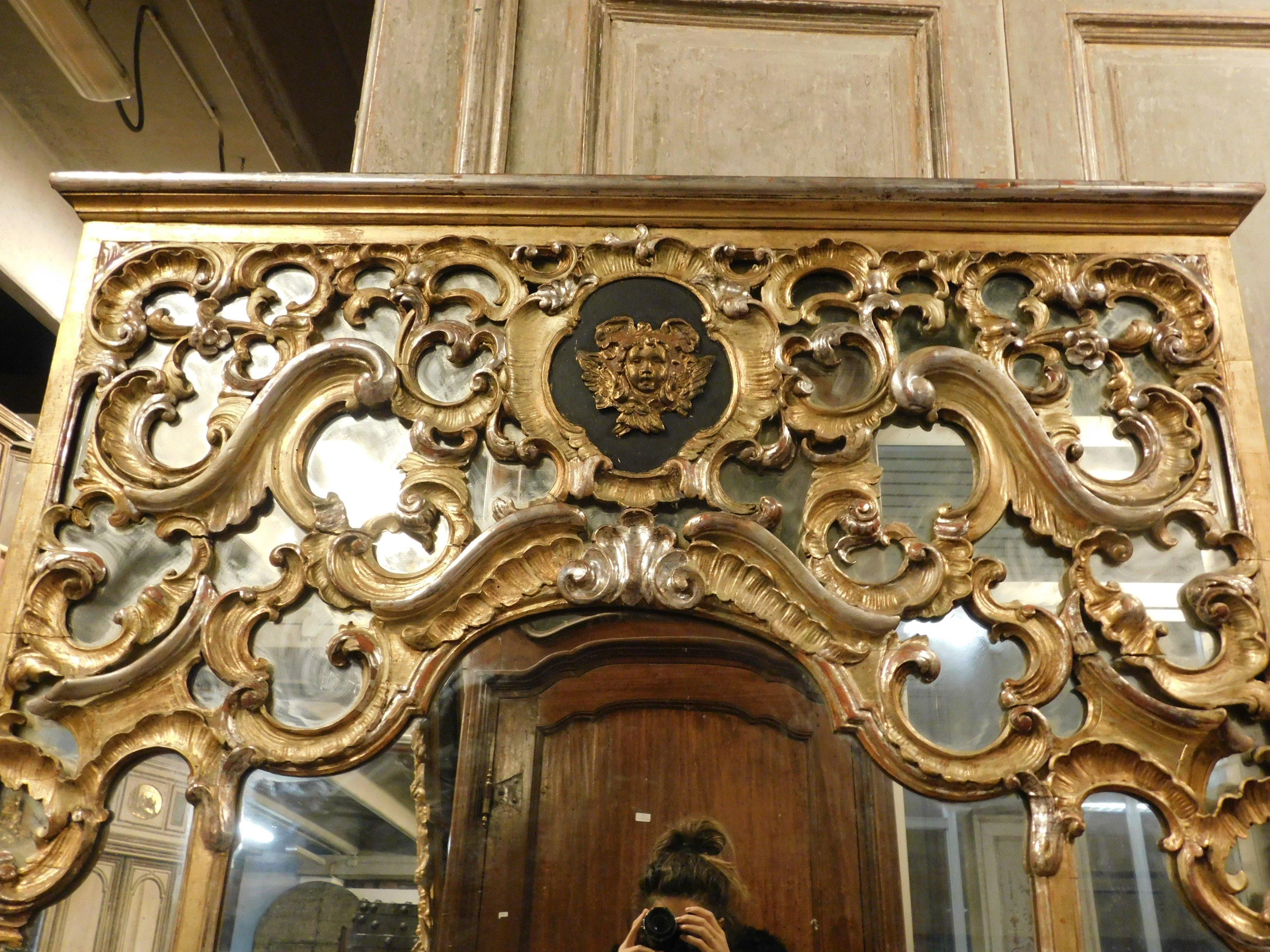 18th Century and Earlier Antique Gilded Wood Mirror, Richly Carved with Putto, 1700, Italy