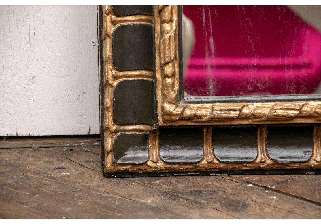 The rectangular glass having a carved, gesso and gilt moulded
surround with alternating black painted decoration.
The inner banding comprised of intertwining ribbon.
Condition is commensurate with age including some stable age cracks and some