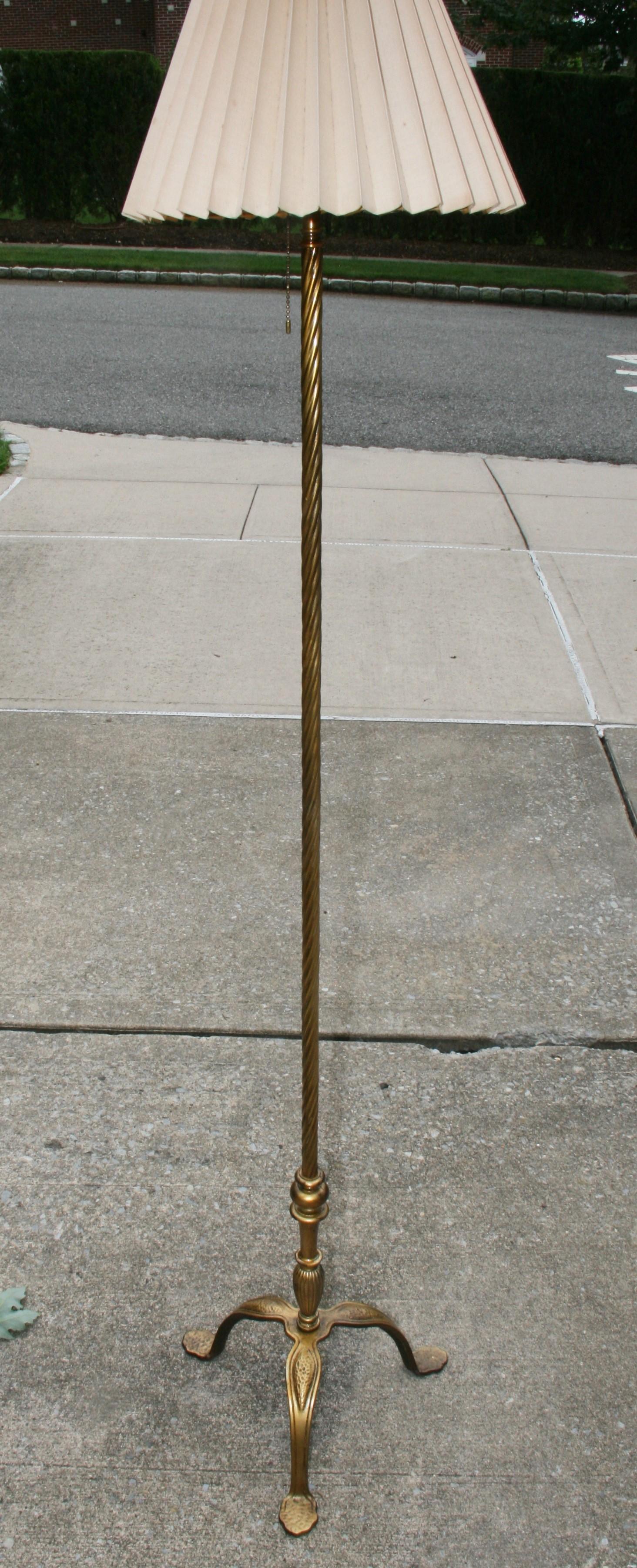 1836 Antique floor  lamp with iron tripode base. Bronze lower stem connected to a spiral brass column. 
Height shown   60 