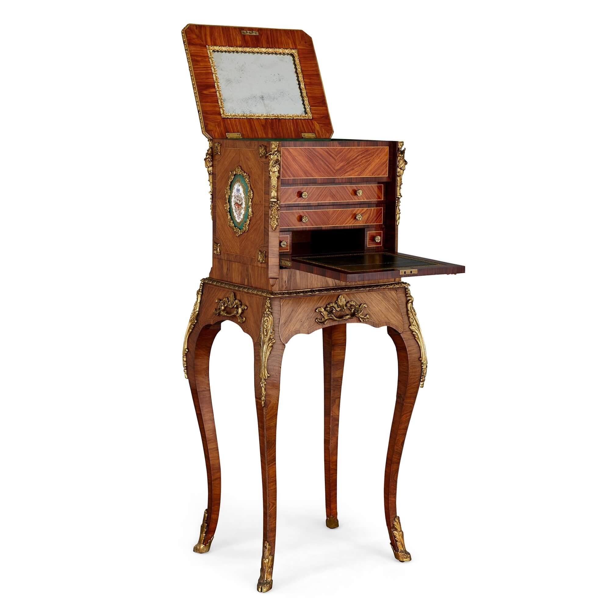 Antique gilt bronze and porcelain mounted dressing and writing cabinet
French, late 19th century
Measures: Height 100cm, width 44cm, depth 38cm

This elegant cabinet functions as both a vanity and a writing table. The cabinet features a