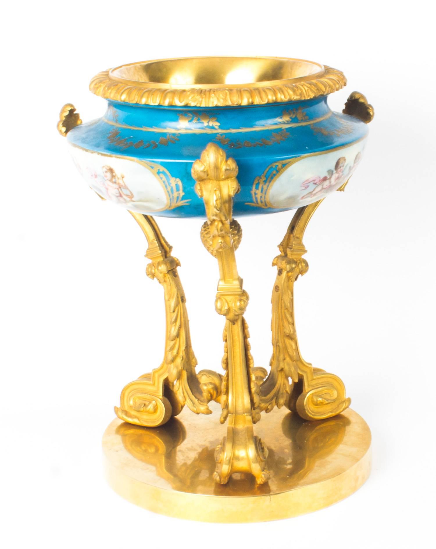 This is a fine antique French neoclassical 19th century gilt bronze and Sèvres Porcelain centrepiece, circa 1860 in-date.
 
The centrepiece is inset with a hand-painted Sèvres Porcelain bowl that features three panels depicting twin cherubs on a