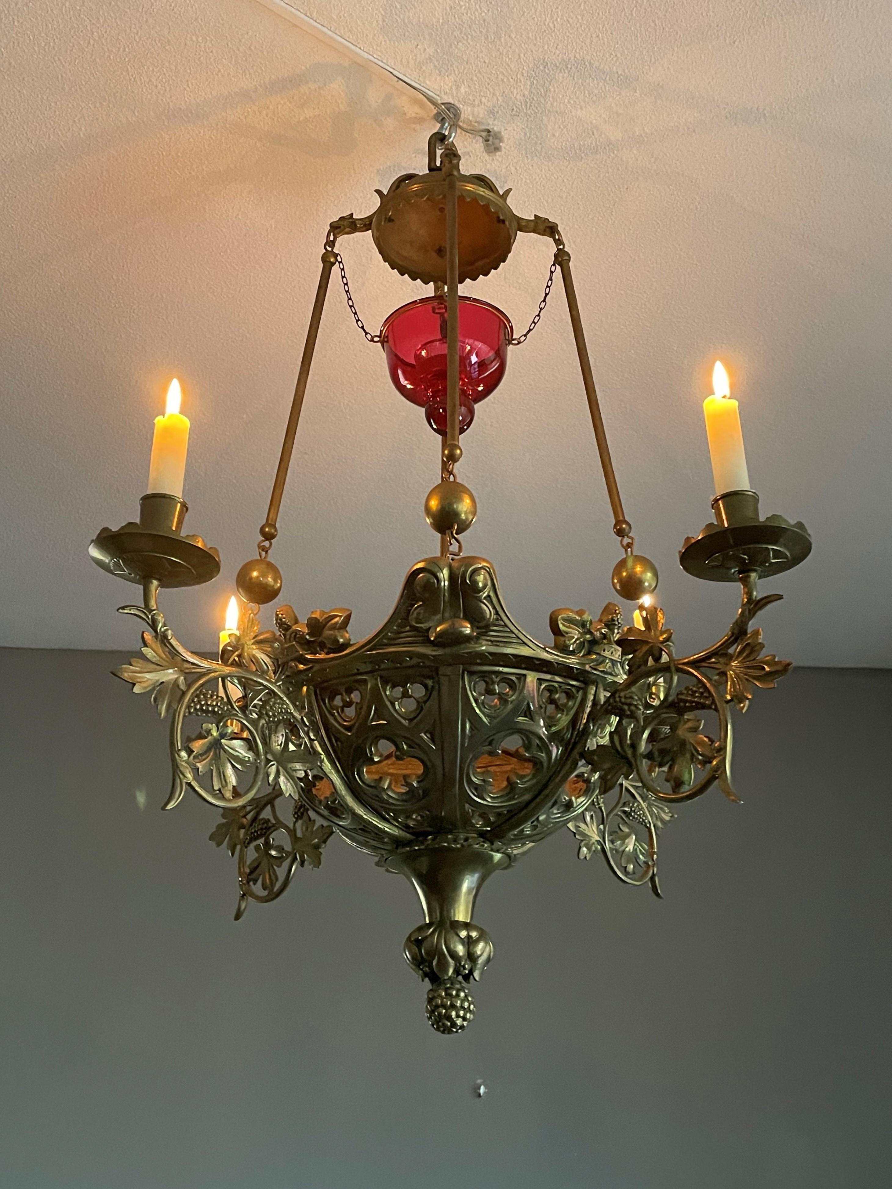 Stunning 19th century Gothic art, four arms candle pendant with gargoyle sculptures and much more.

This late 1800s church relic truly has an aura of religiousness about it. This sanctuary pendant is entirely handcrafted and for the most part in