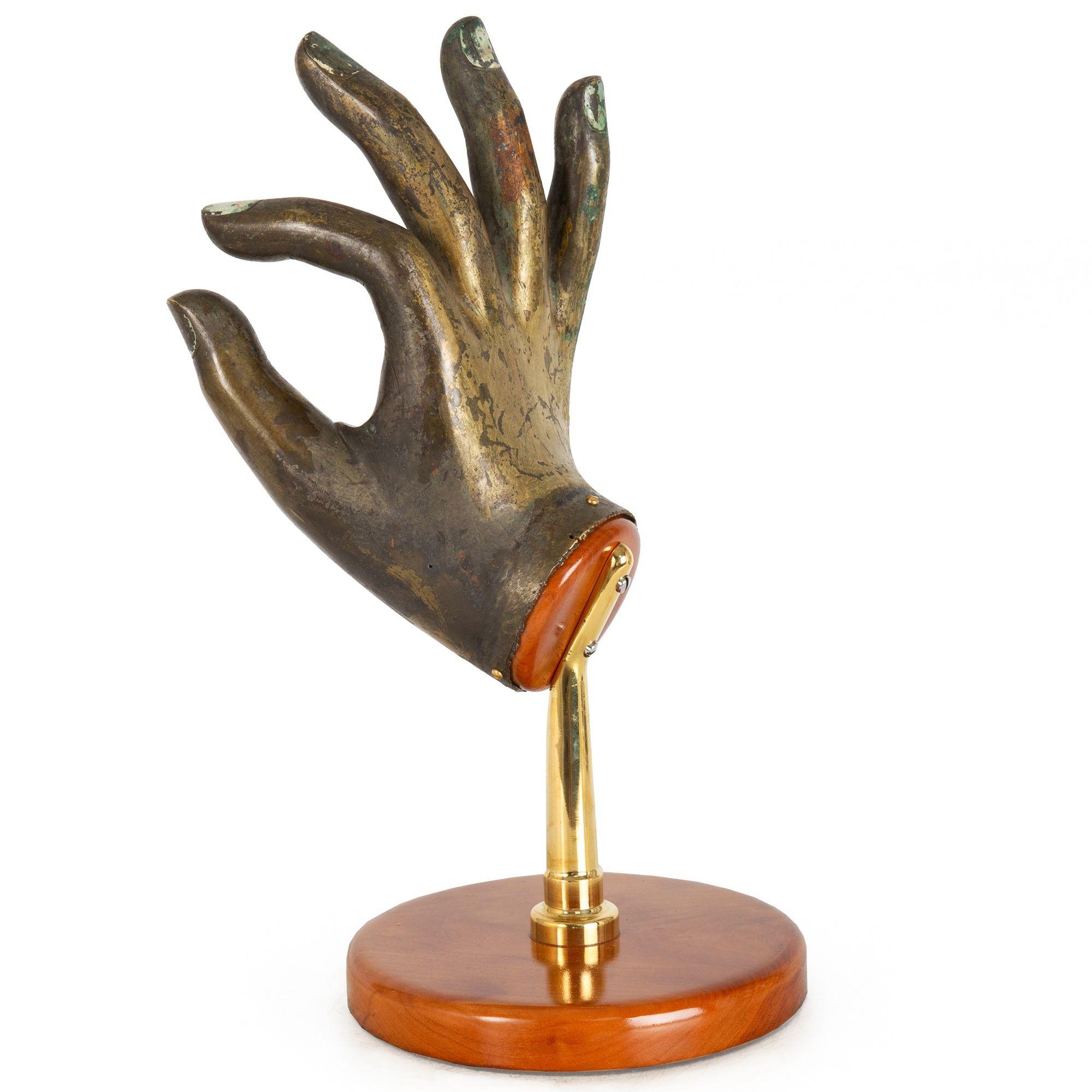 BRONZE GILT BUDDHA HAND IN VITARKA MUDRA
Himalayan, probably late 19th/early 20th century

16 7/8