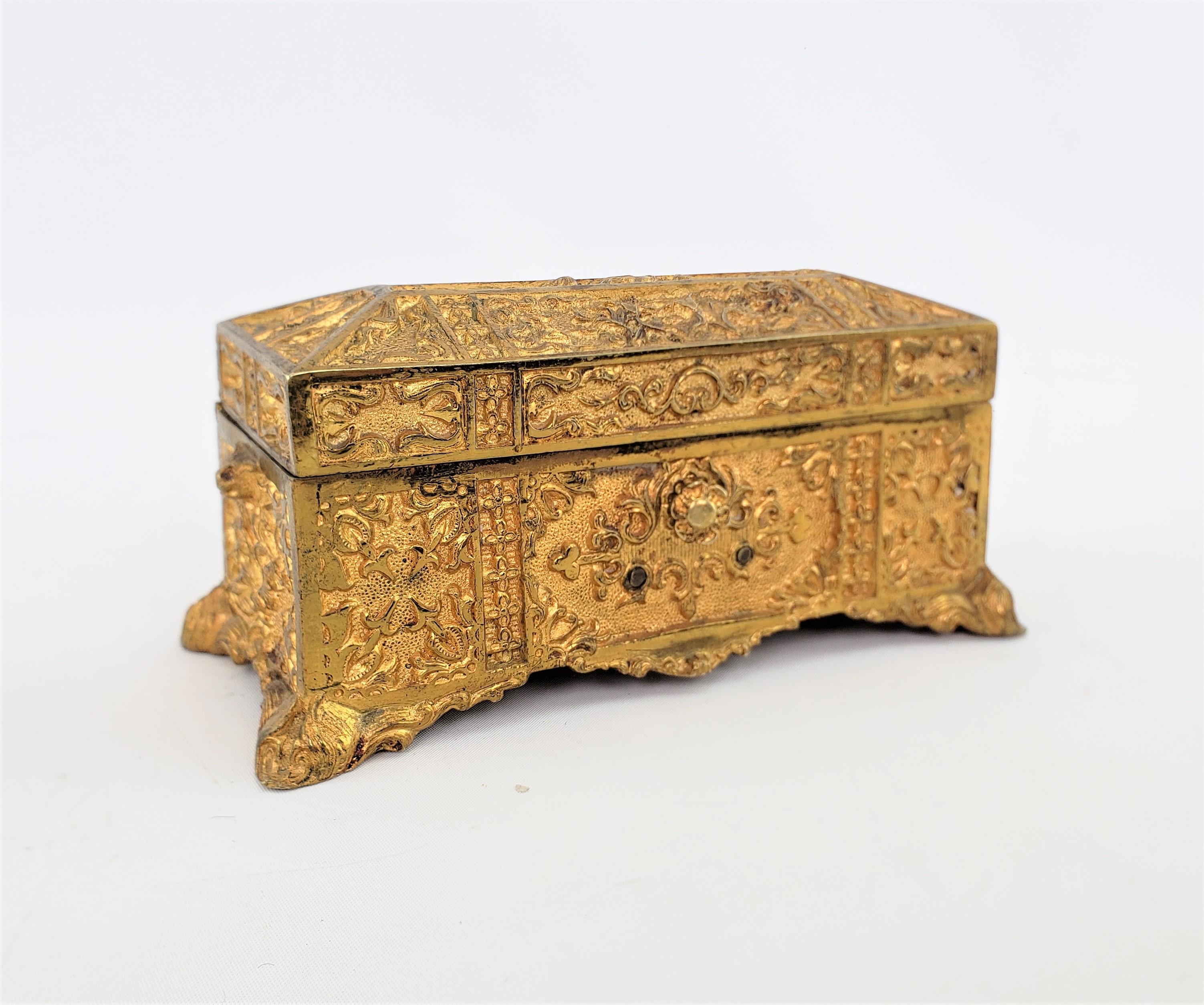 This antique gilt bronze decorative or jewelry box is unsigned, but presumed to have originated from France and dates to approximately 1900 and done in a Renaissance Revival style. The box is composed of cast bronze with a gilt finish and has a