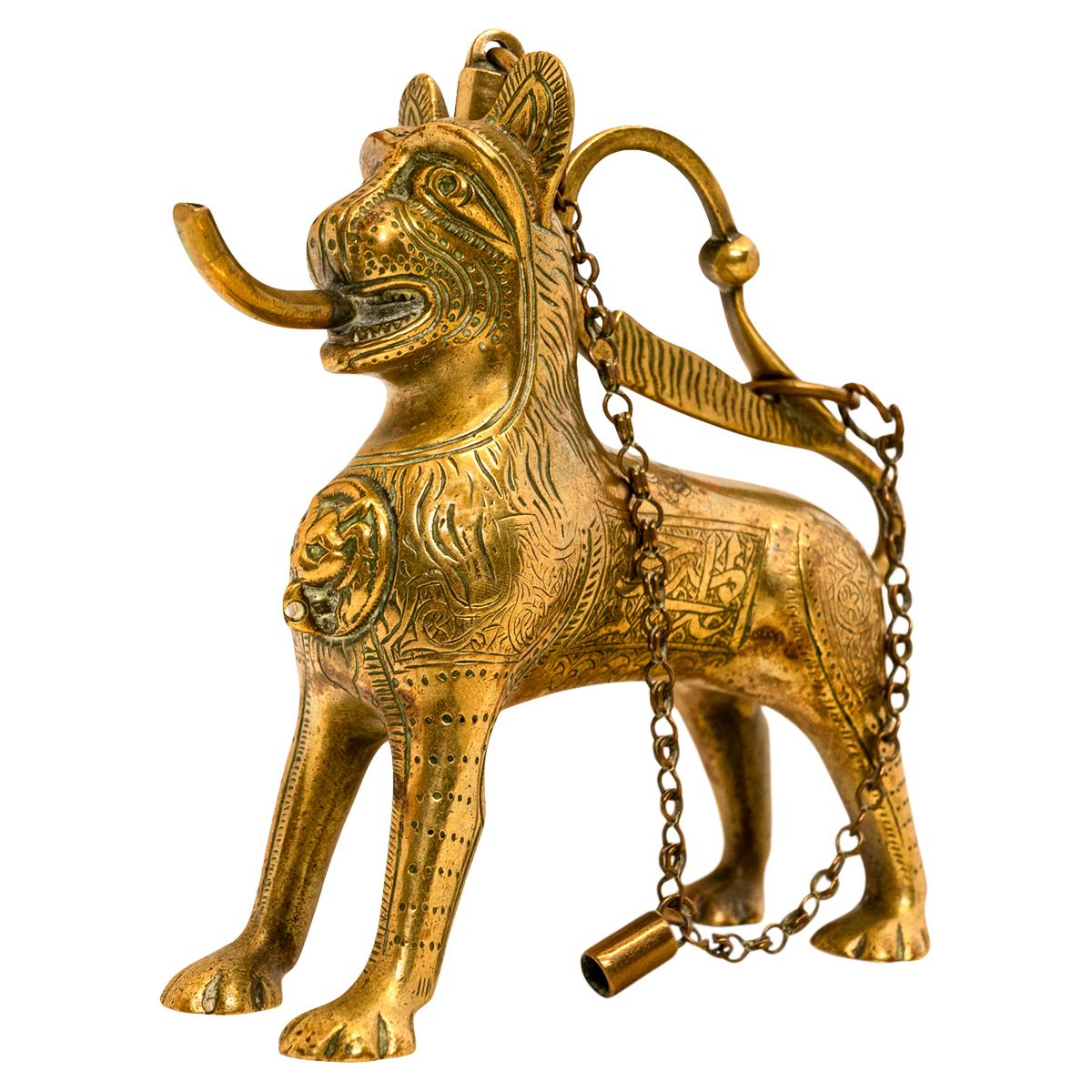 A good antique cast & gilt bronze Islamic engraved lion shaped aquamanile or table lighter/lamp, circa 1860.
The gilt bronze figure is finely modeled as a lion with engraved decoration and two engraved panels of calligraphy on each side of the