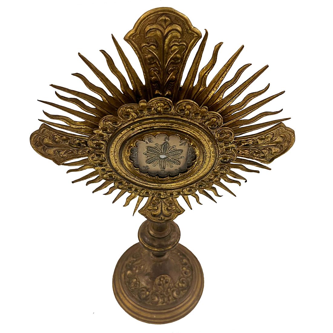 A late 19th Century French gilt bronze reliquary with removable glass insets that hold an embroidered sachet.

Measurements:
Height: 14.5