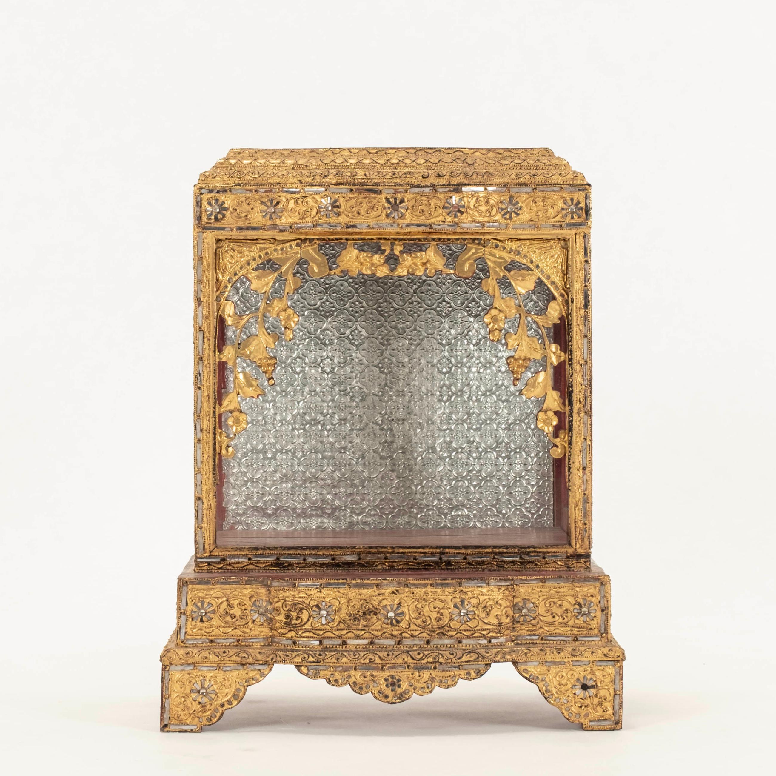 Burmese hand-carved Buddha temple shrine featuring gilded wood, glass  and a metal repoussé interior back.

Visit our other 1STDIBS storefront Moxie Interiors to shop a vast array of exceptional home furnishings!