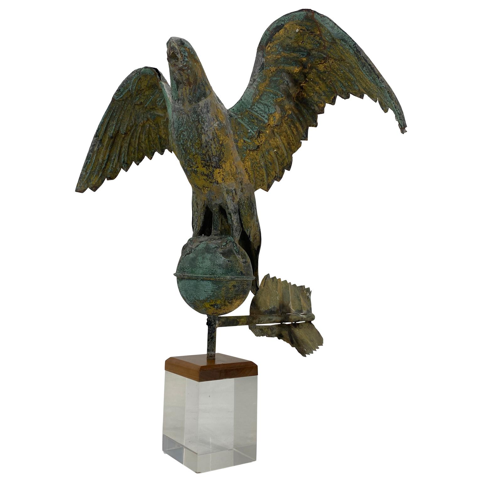 American diminutive eagle weathervane on globe with amazing patina and mounted on a custom made Lucite and wood stand, circa 1850.

 